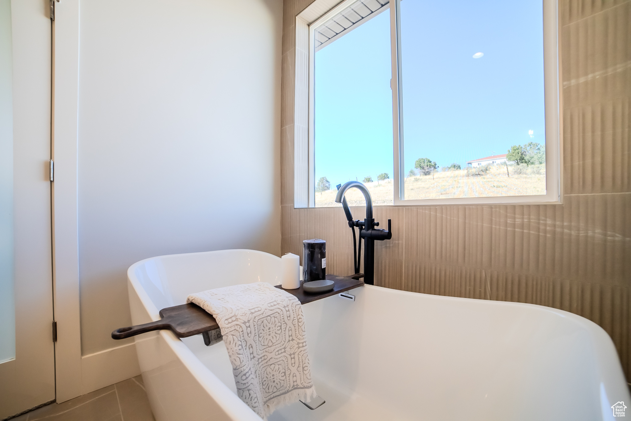 Interior space with a bathtub and tile patterned floors