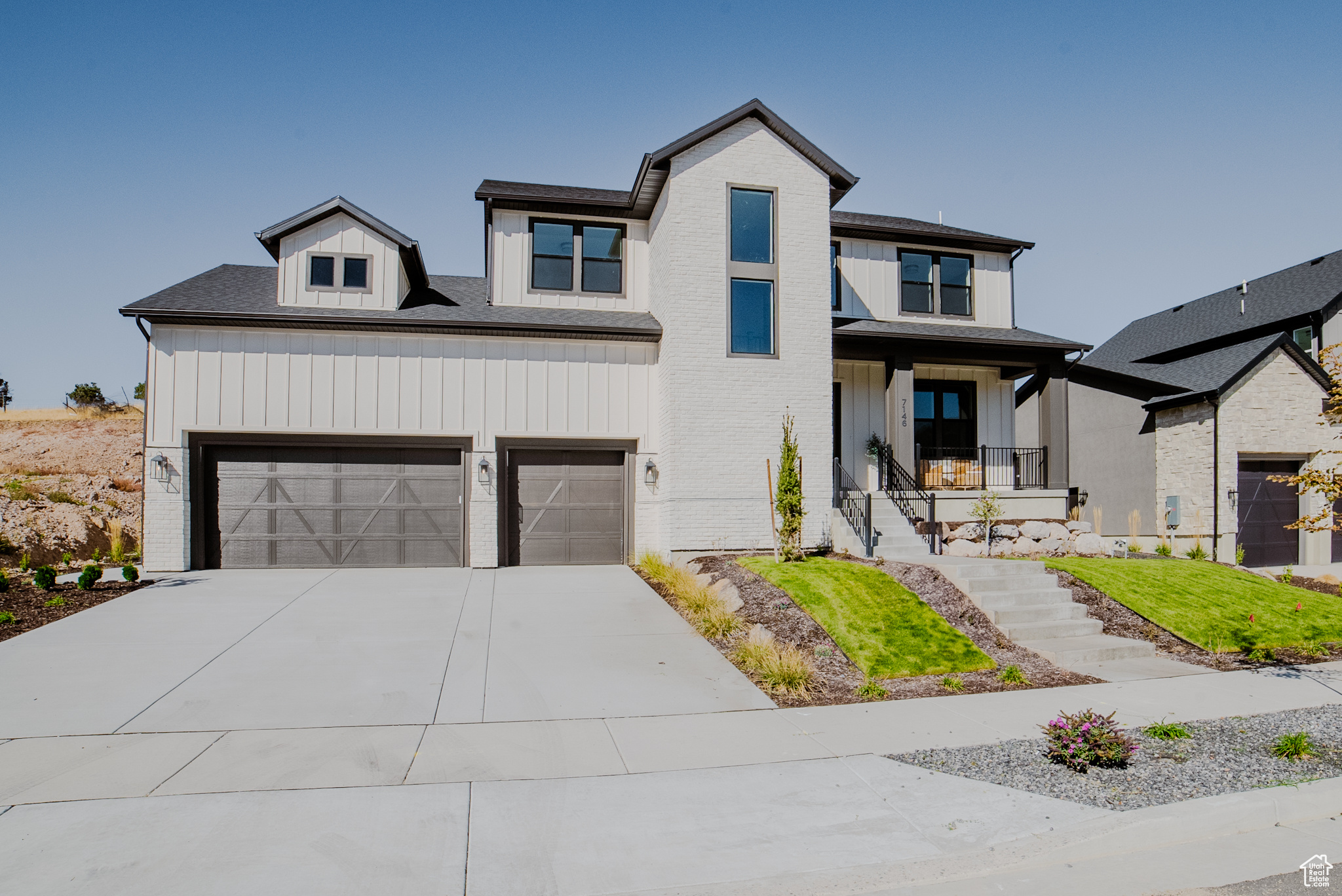 View of front of property with covered porch and a garage