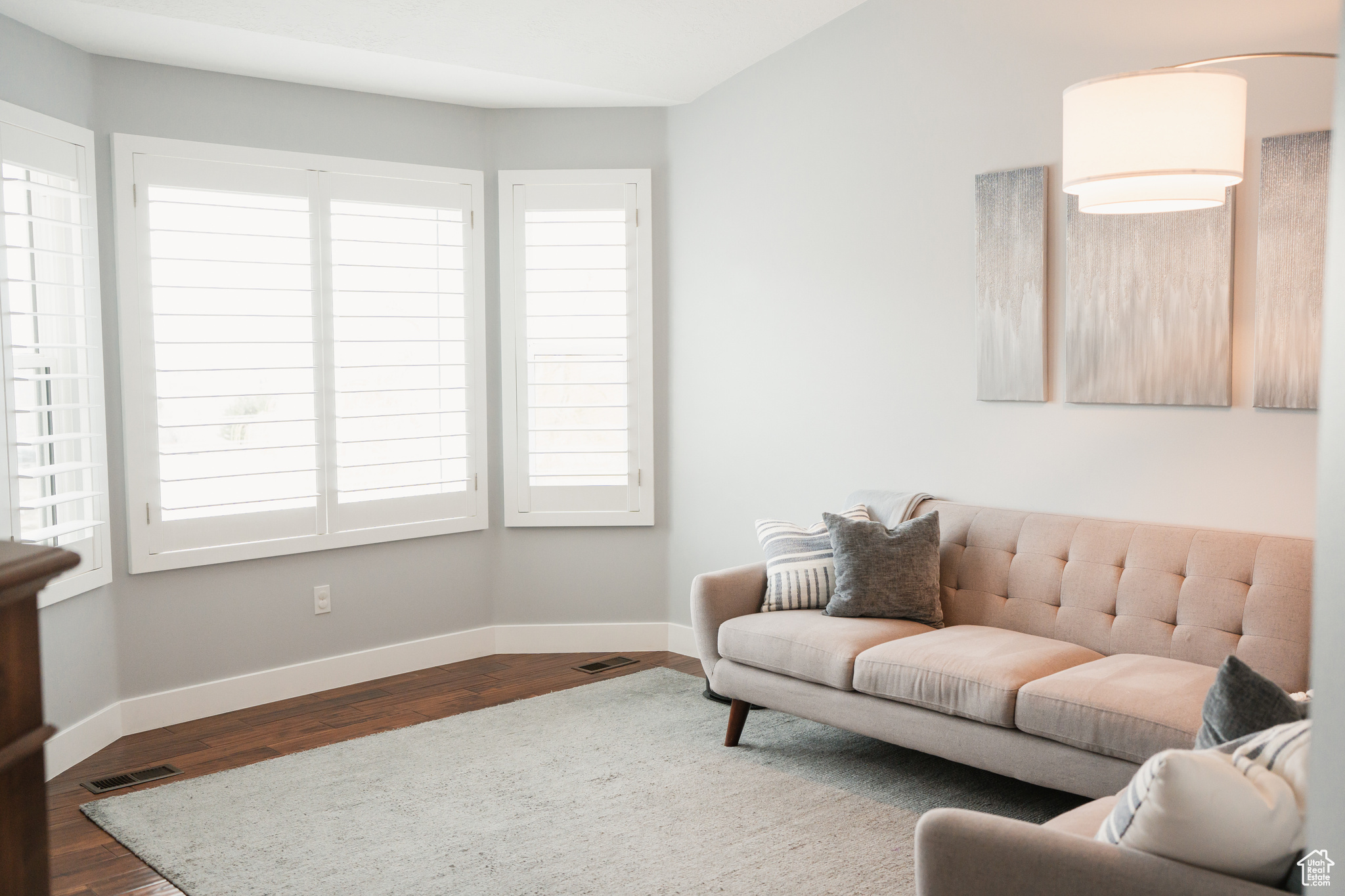 Inviting Living Room with Bay Window & Plantation Shutters