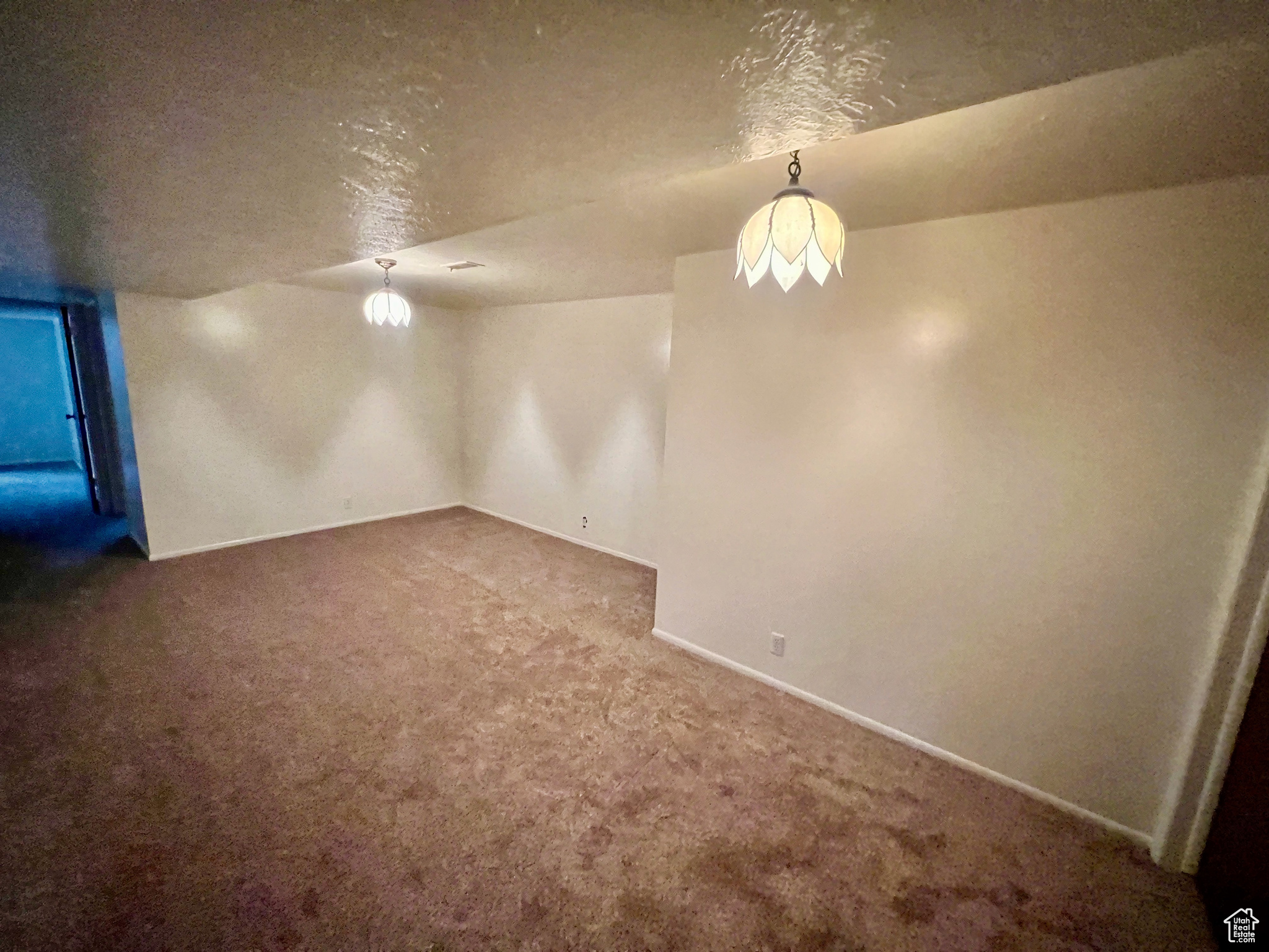 Interior space featuring carpet floors and a textured ceiling