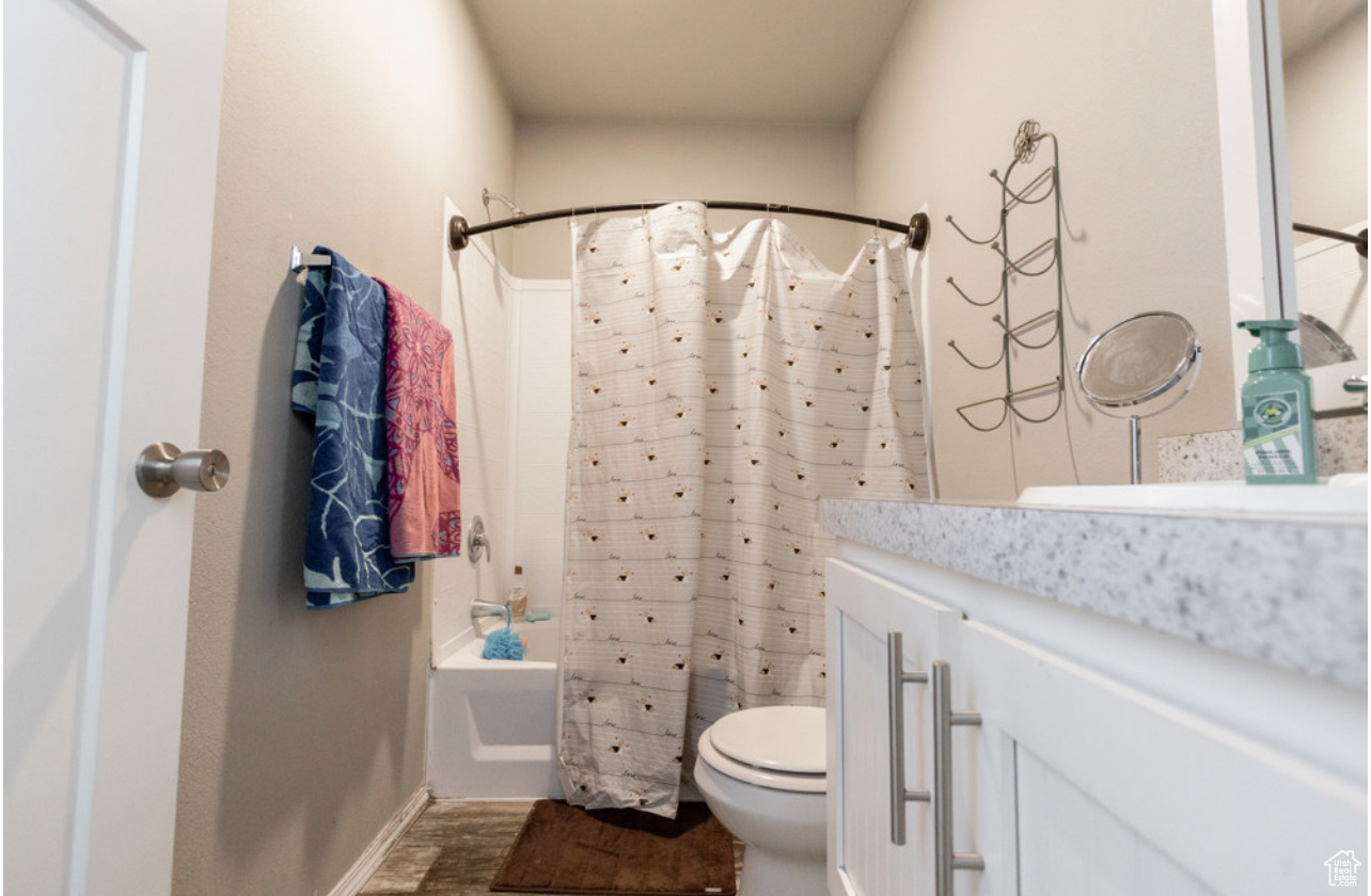 Full bathroom with vanity, toilet, and shower / tub combo