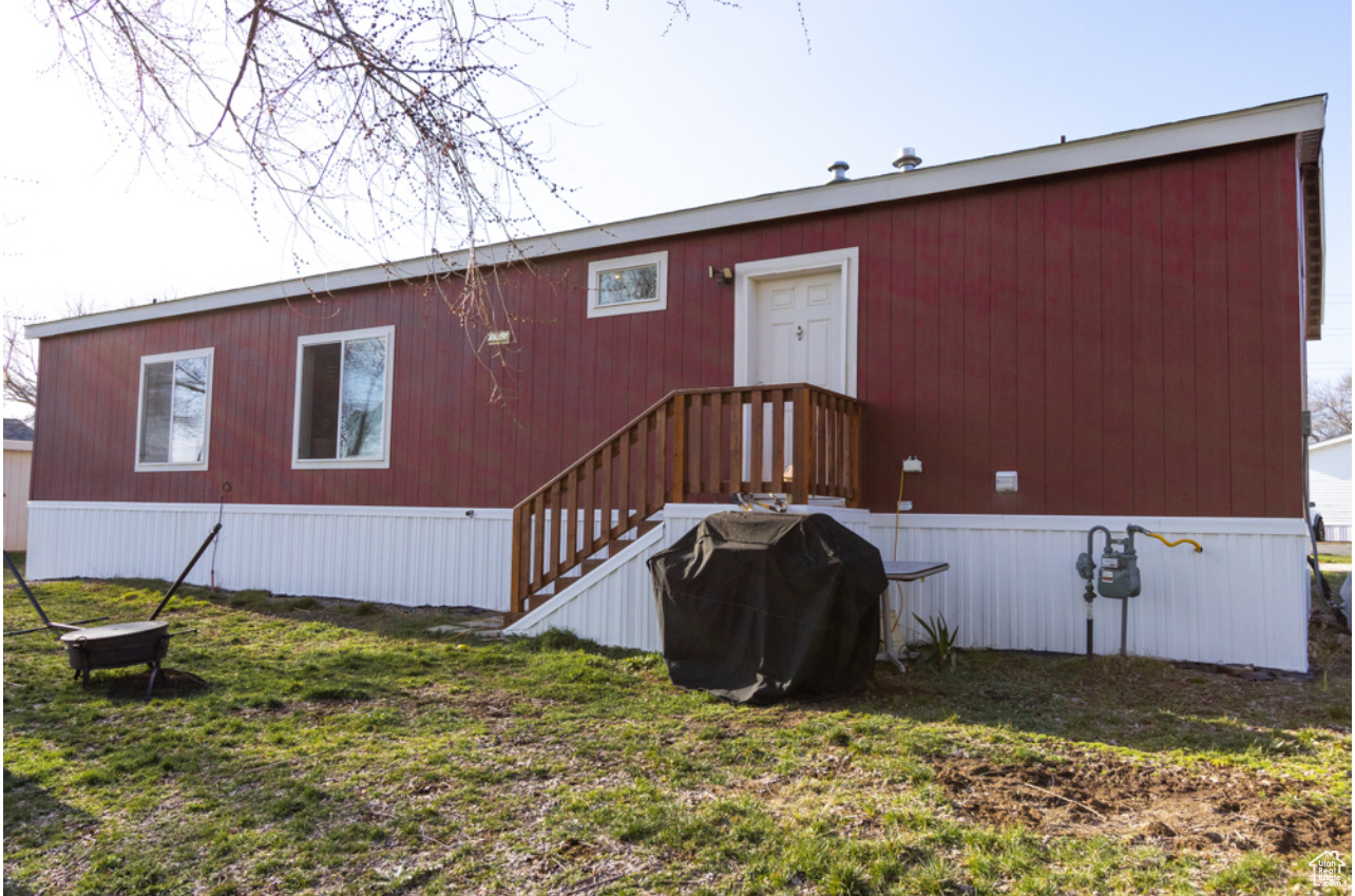 Back of property featuring a yard