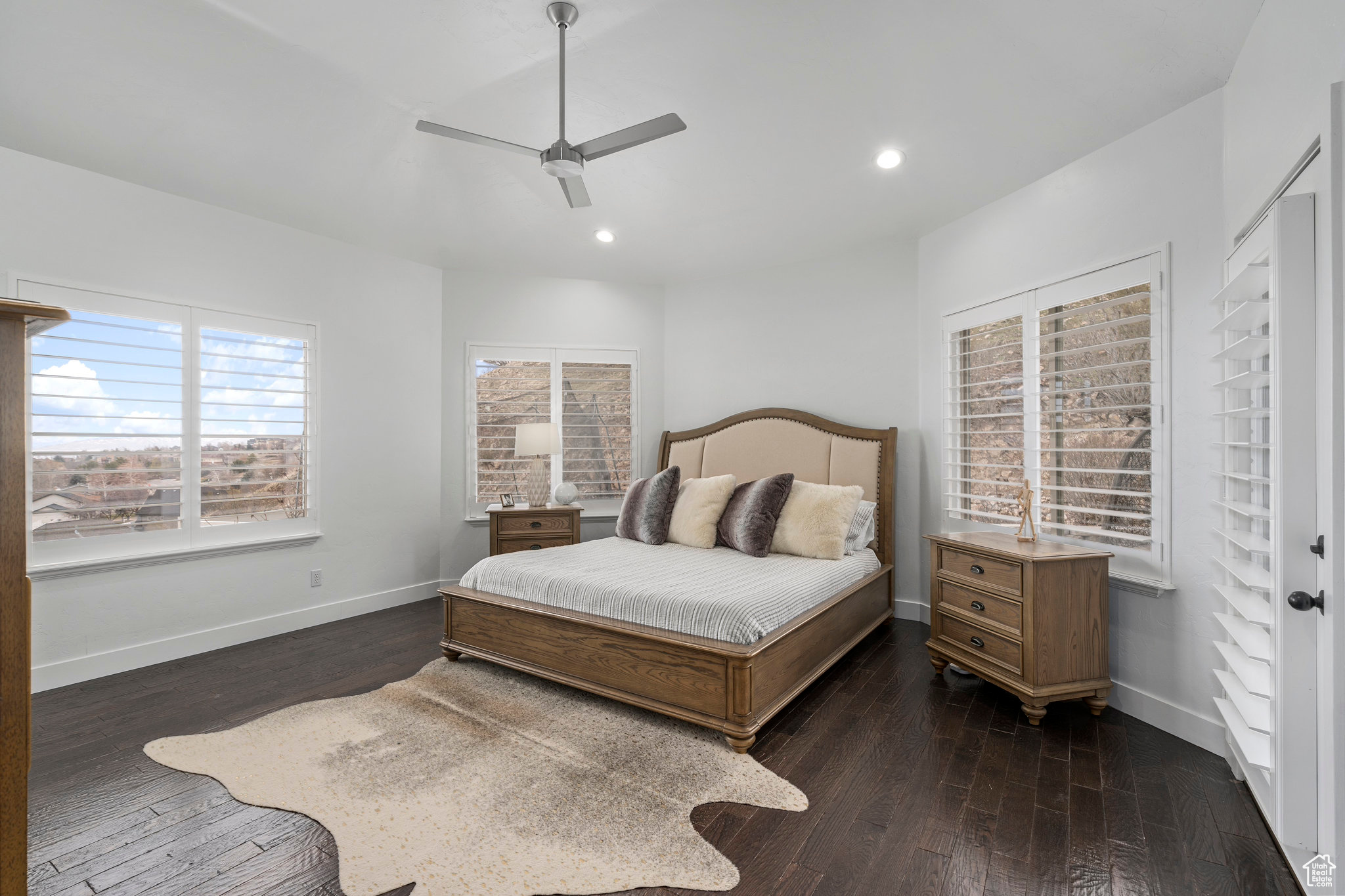 Primary Bedroom with a view featuring dark hardwood / wood-style floors and ceiling fan