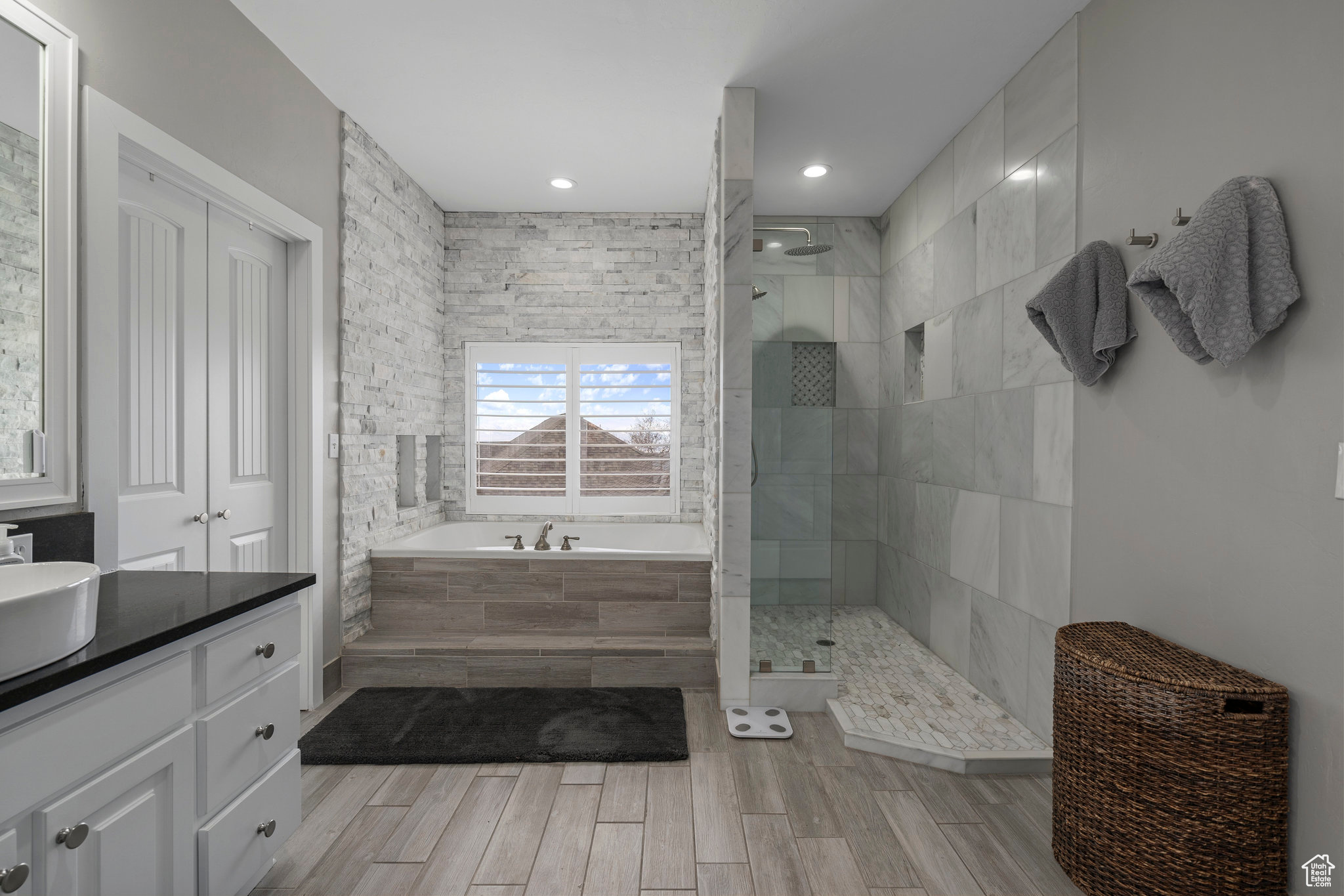 Primary bathroom featuring separate shower and tub and vanity