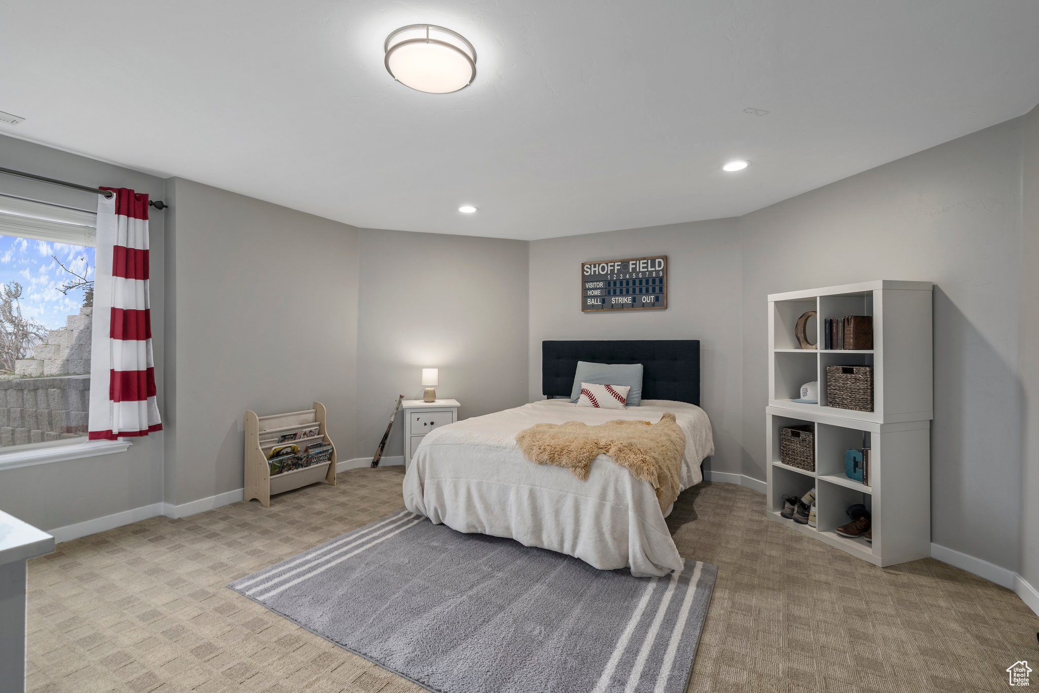Huge basement bedroom featuring light carpet and above ground windows