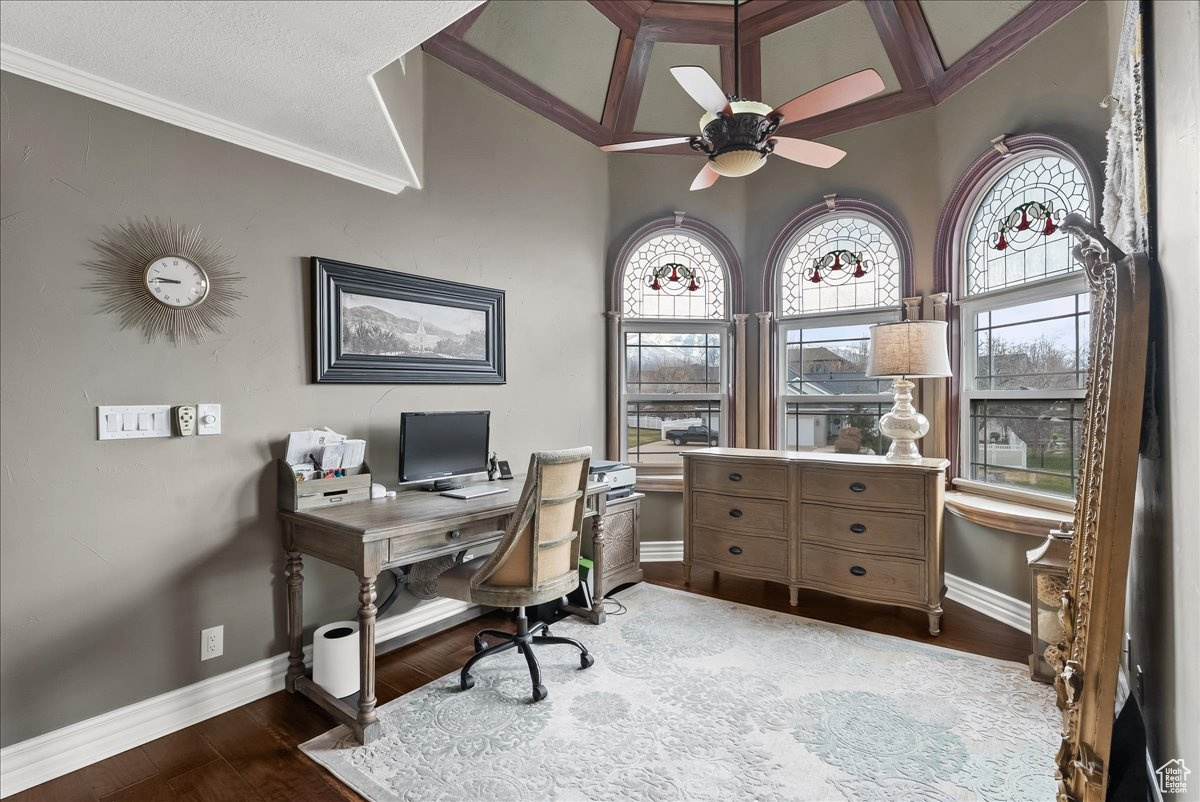 Office with dark hardwood / wood-style flooring, ornamental molding, and ceiling fan