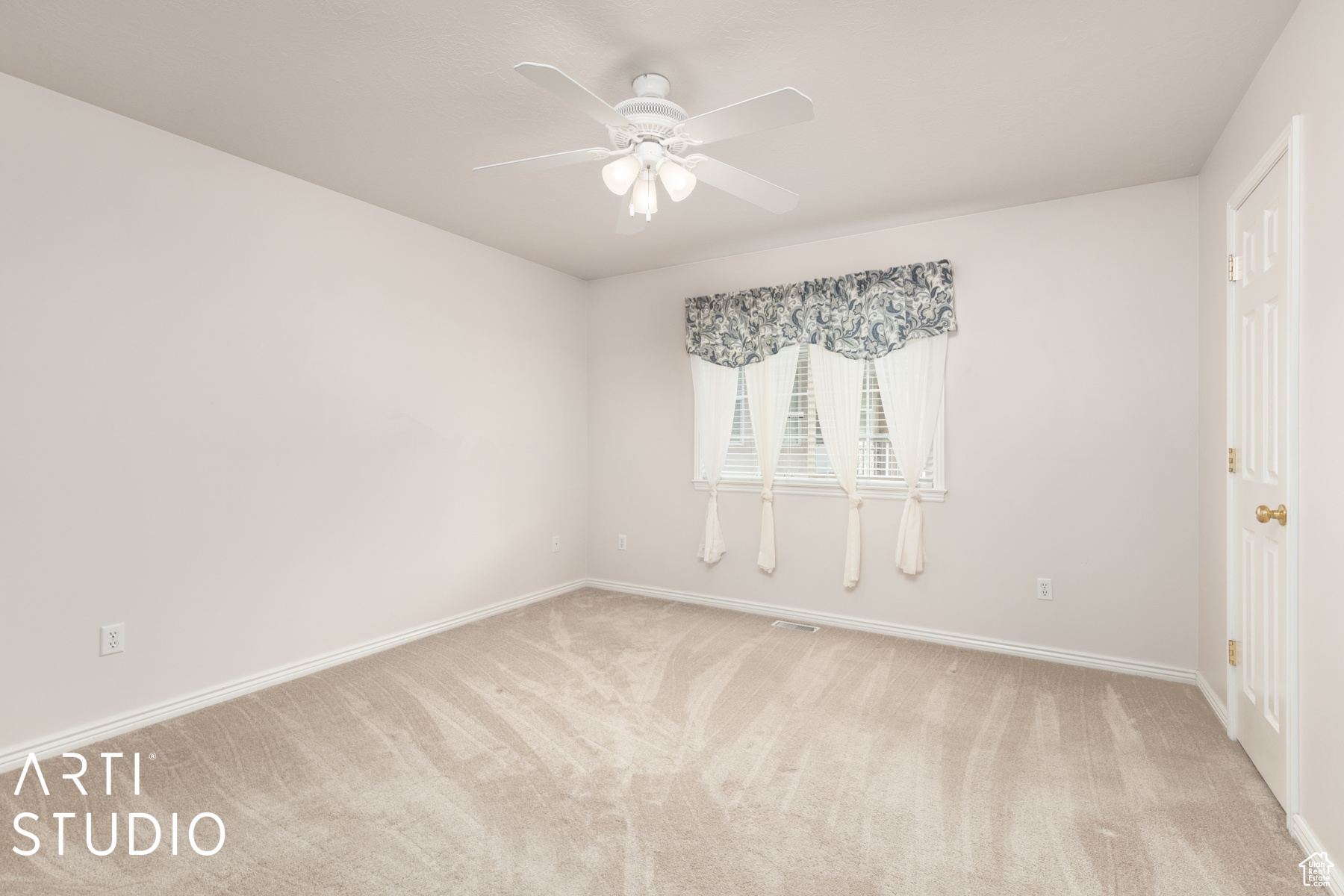 Unfurnished room featuring light carpet and ceiling fan