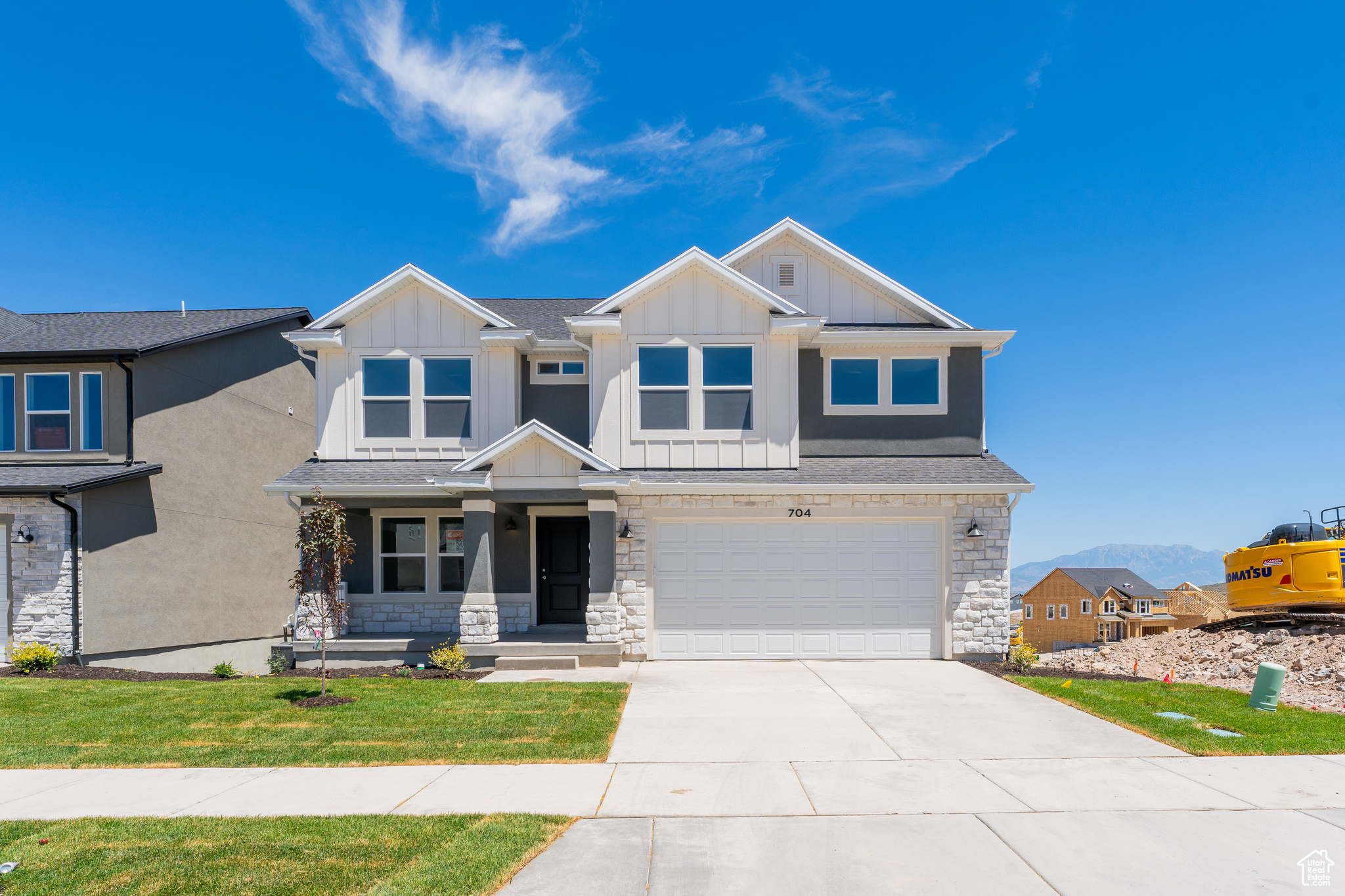 Craftsman house with a garage and a front yard