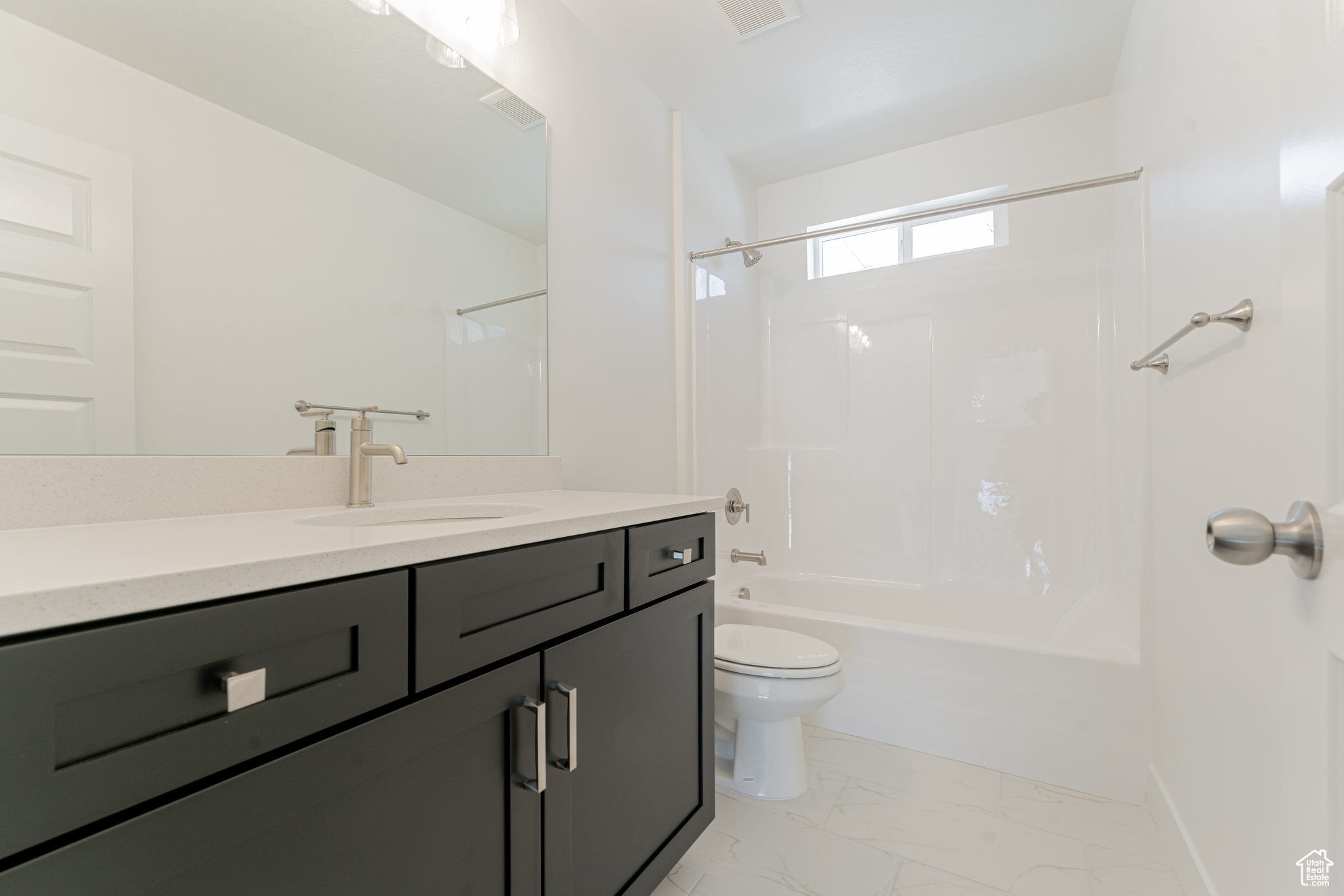 Full bathroom featuring tile patterned flooring, shower / bath combination, toilet, and vanity