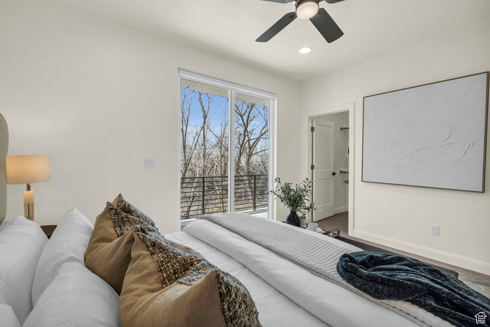 Carpeted bedroom featuring ceiling fan