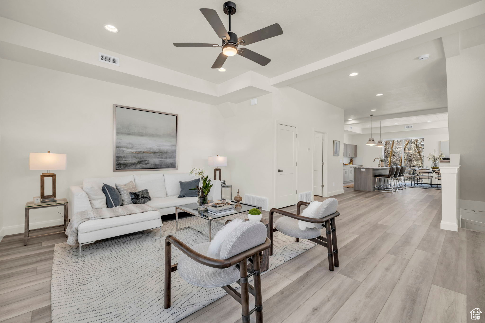 Living room with light hardwood / wood-style flooring and ceiling fan