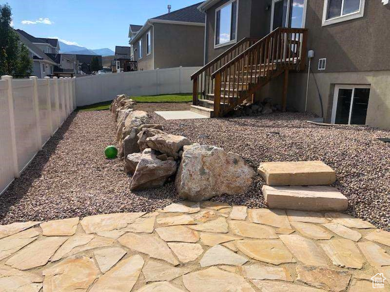New Xeriscaped Section of the yard with Flagstone Patio and retaining wall  Out back