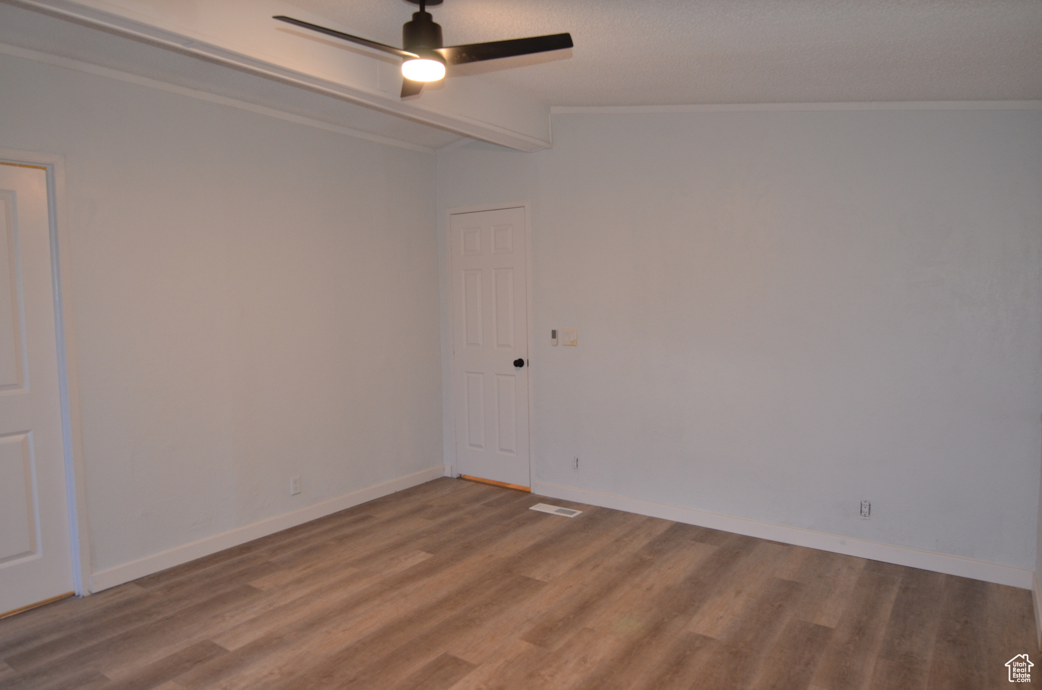 Master bedroom with LVP flooring, vaulted ceiling, and ceiling fan