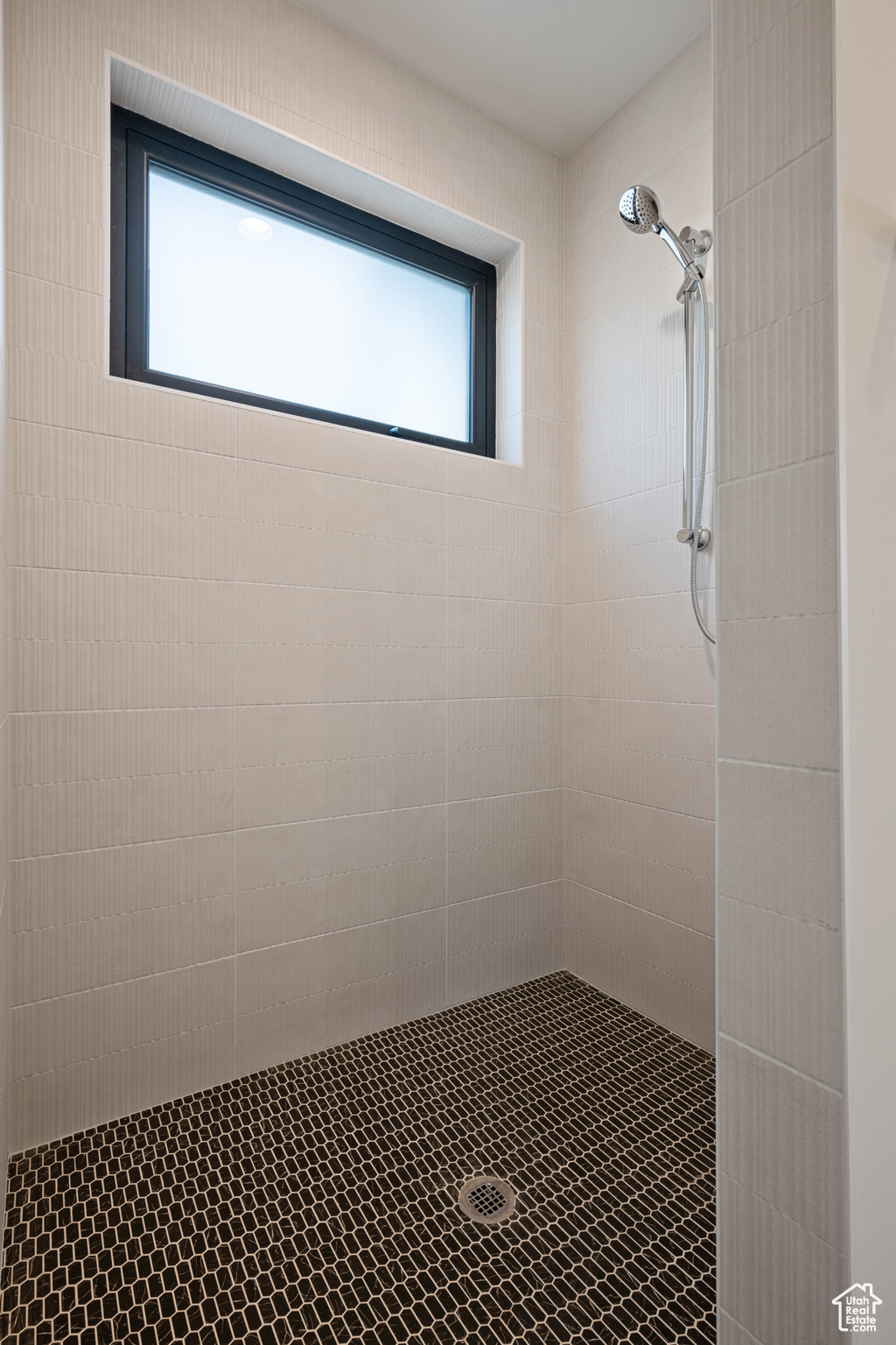 Bathroom with a tile shower and a wealth of natural light