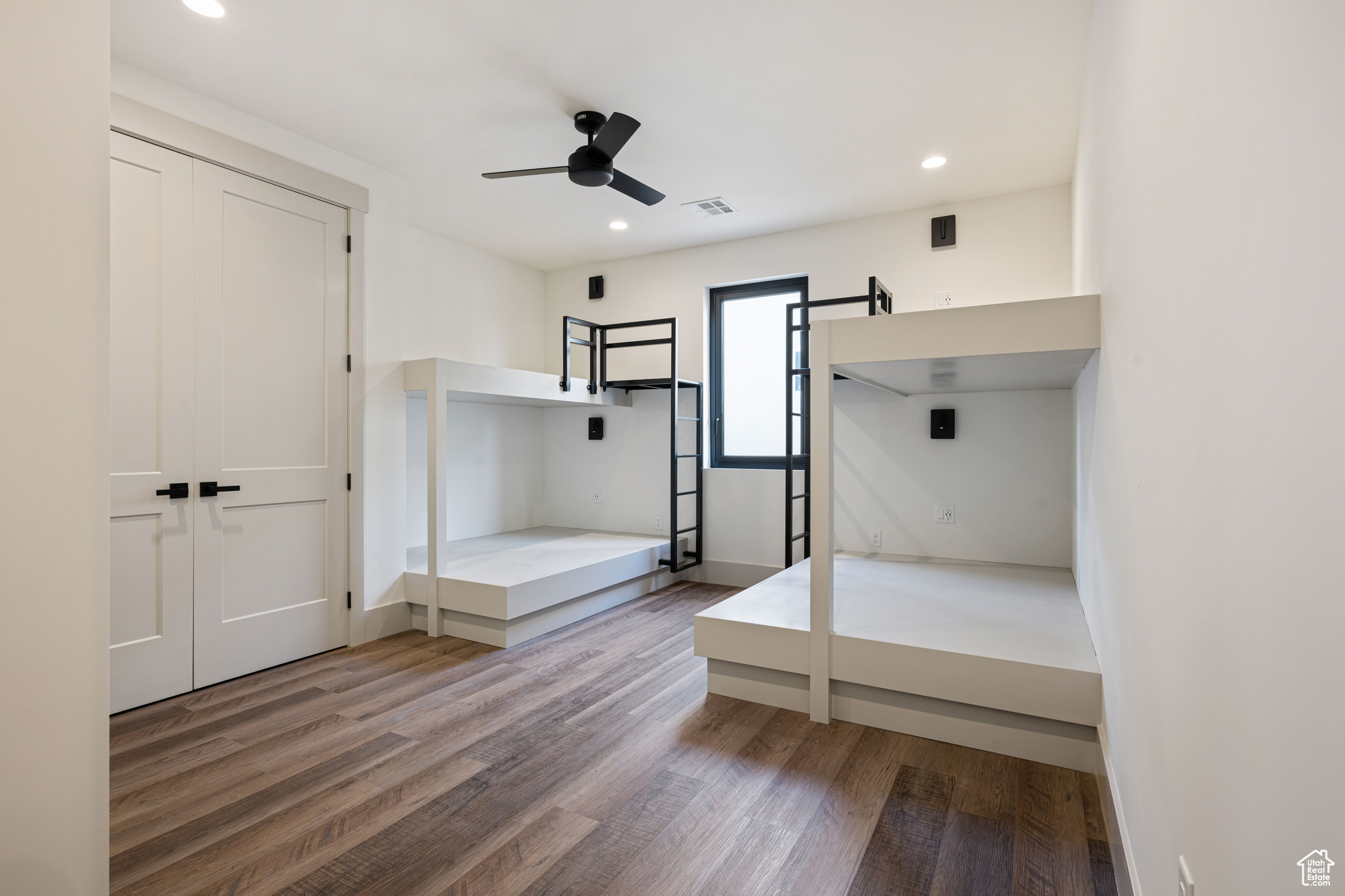 Unfurnished bedroom with a closet, light hardwood / wood-style floors, and ceiling fan