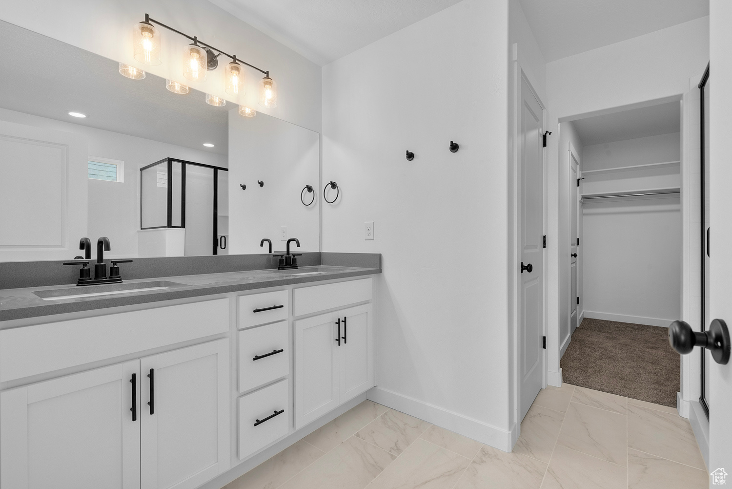 Bathroom featuring tile patterned floors and double sink vanity