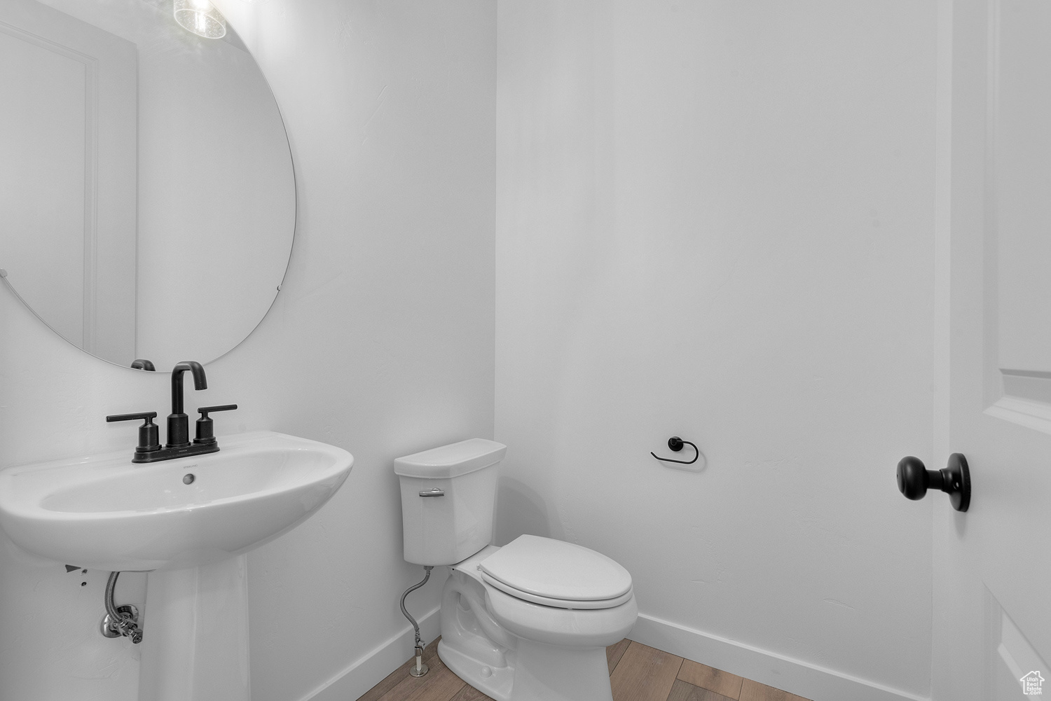 Bathroom with toilet and hardwood / wood-style flooring