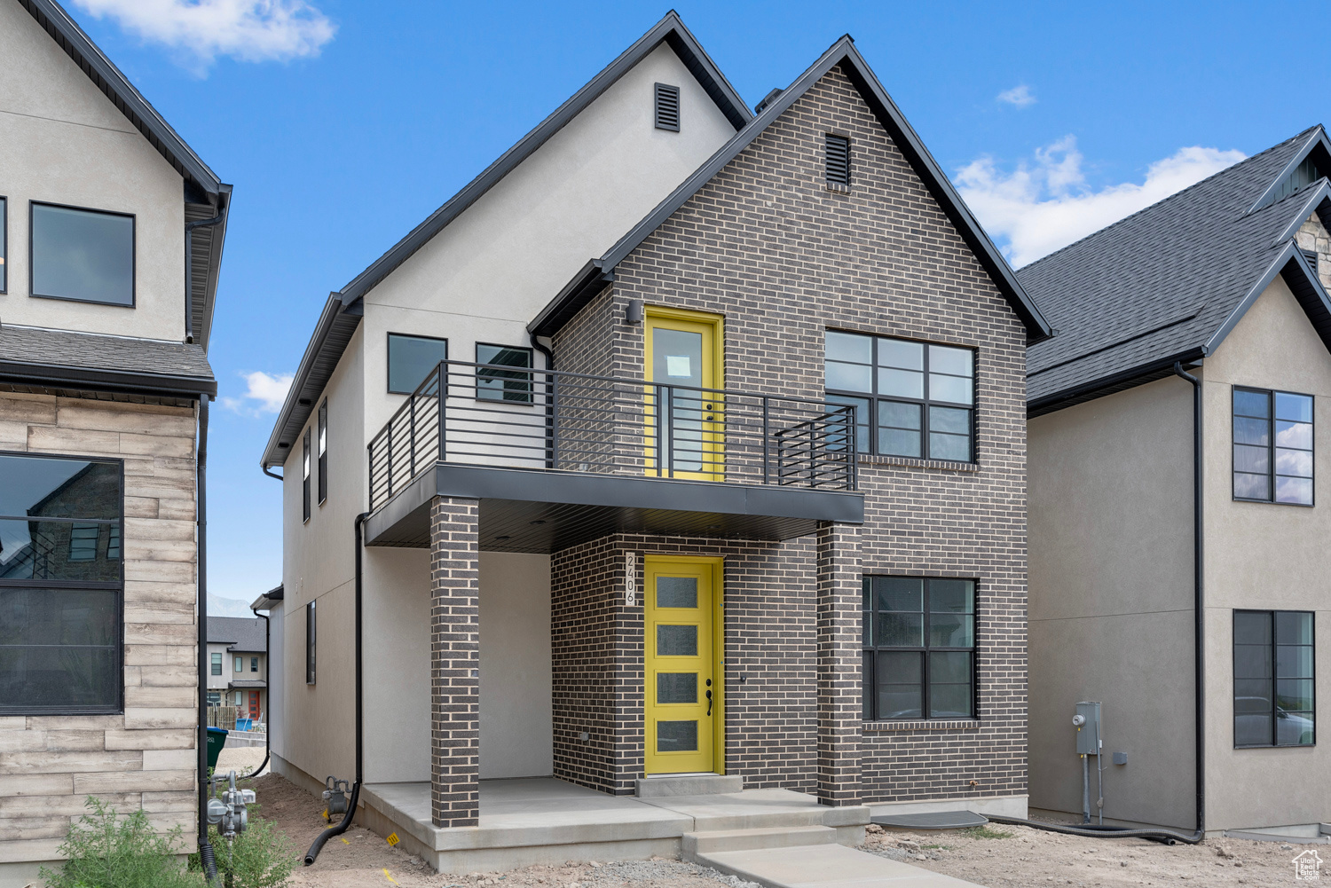 View of front of house with a balcony