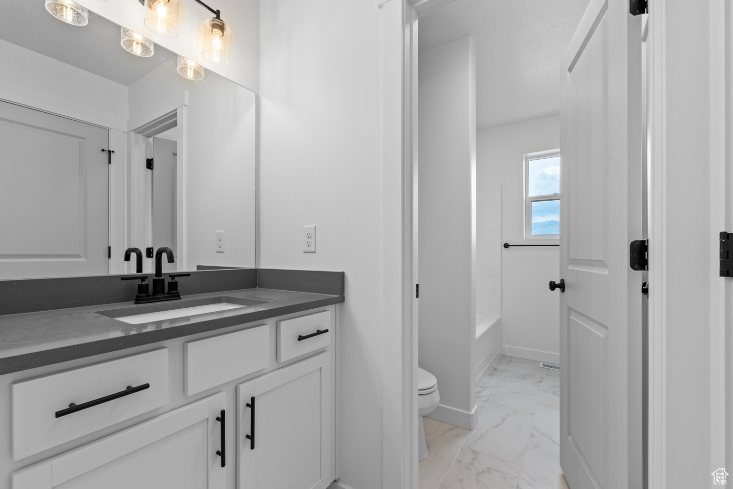 Full bathroom featuring vanity, toilet, tile patterned floors, and bathing tub / shower combination