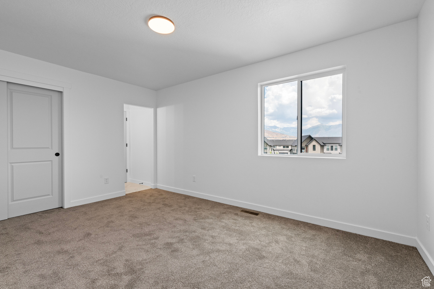 Unfurnished bedroom featuring a closet and carpet floors