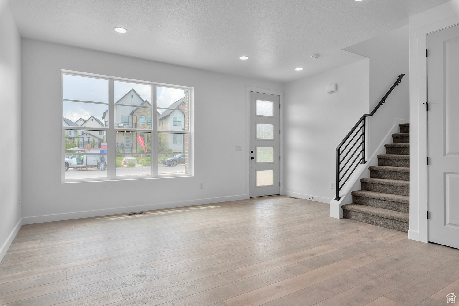 Foyer entrance with light hardwood / wood-style floors