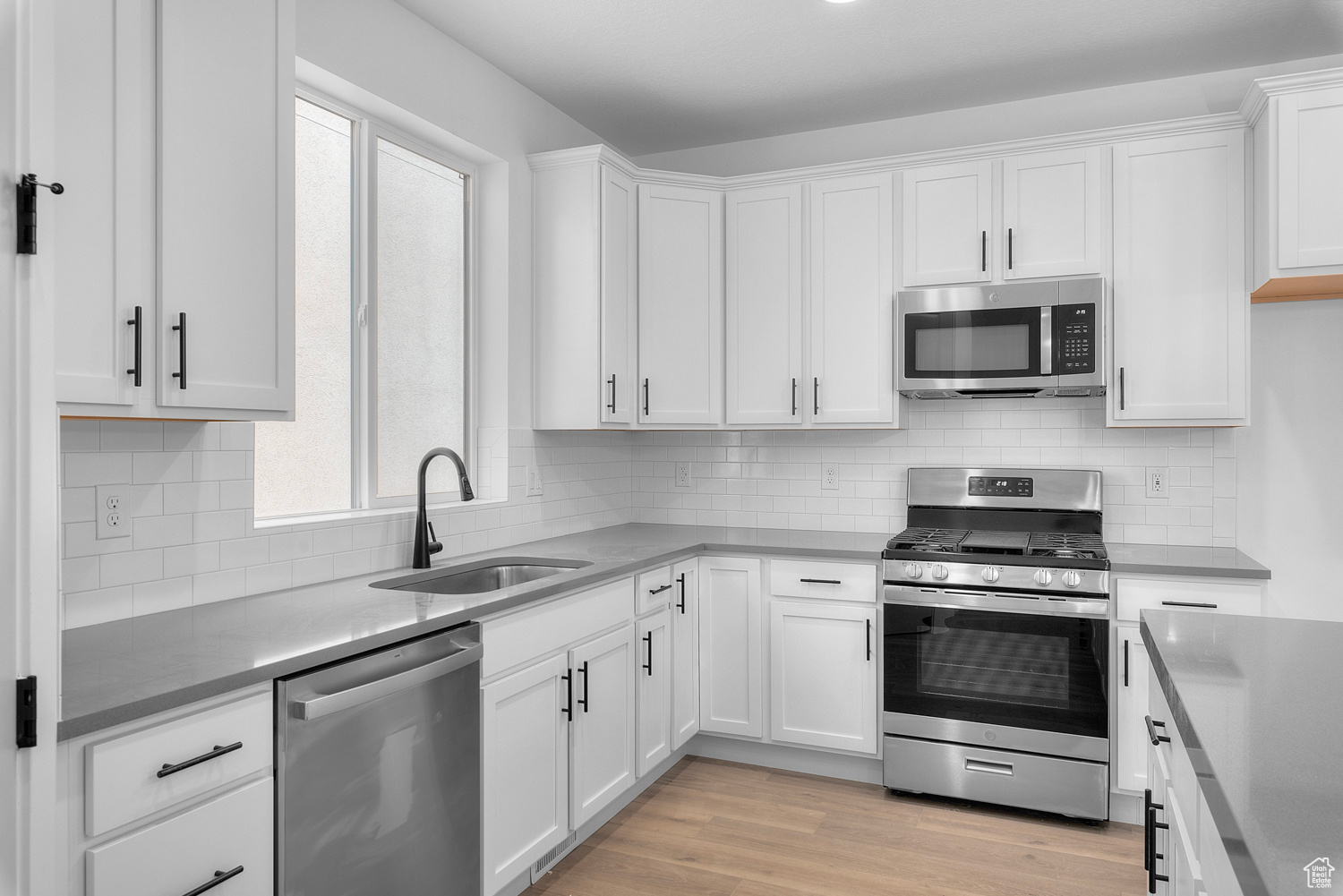 Kitchen featuring light hardwood / wood-style floors, sink, a wealth of natural light, and stainless steel appliances