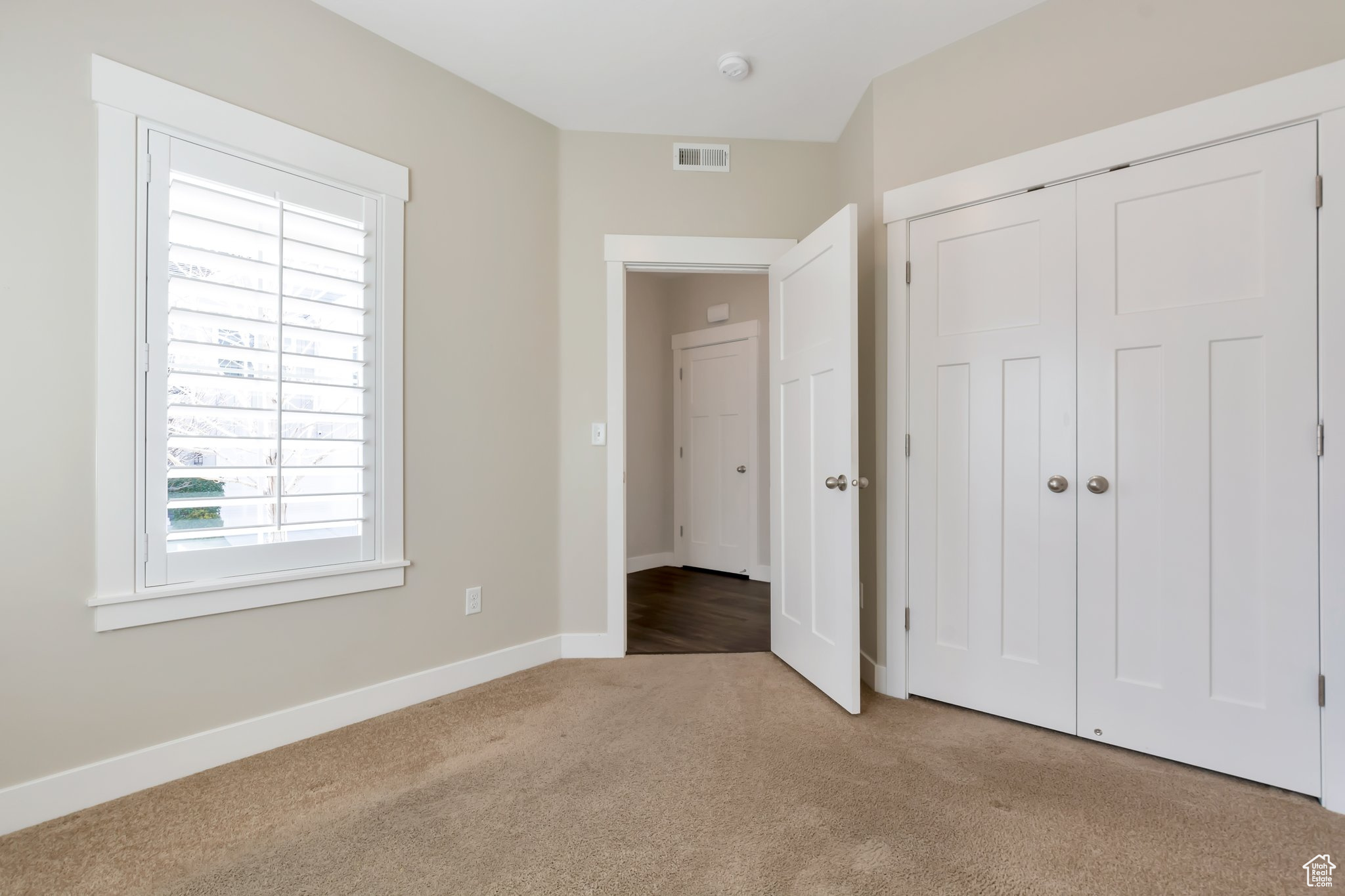 Unfurnished bedroom with light hardwood / wood-style flooring and a closet