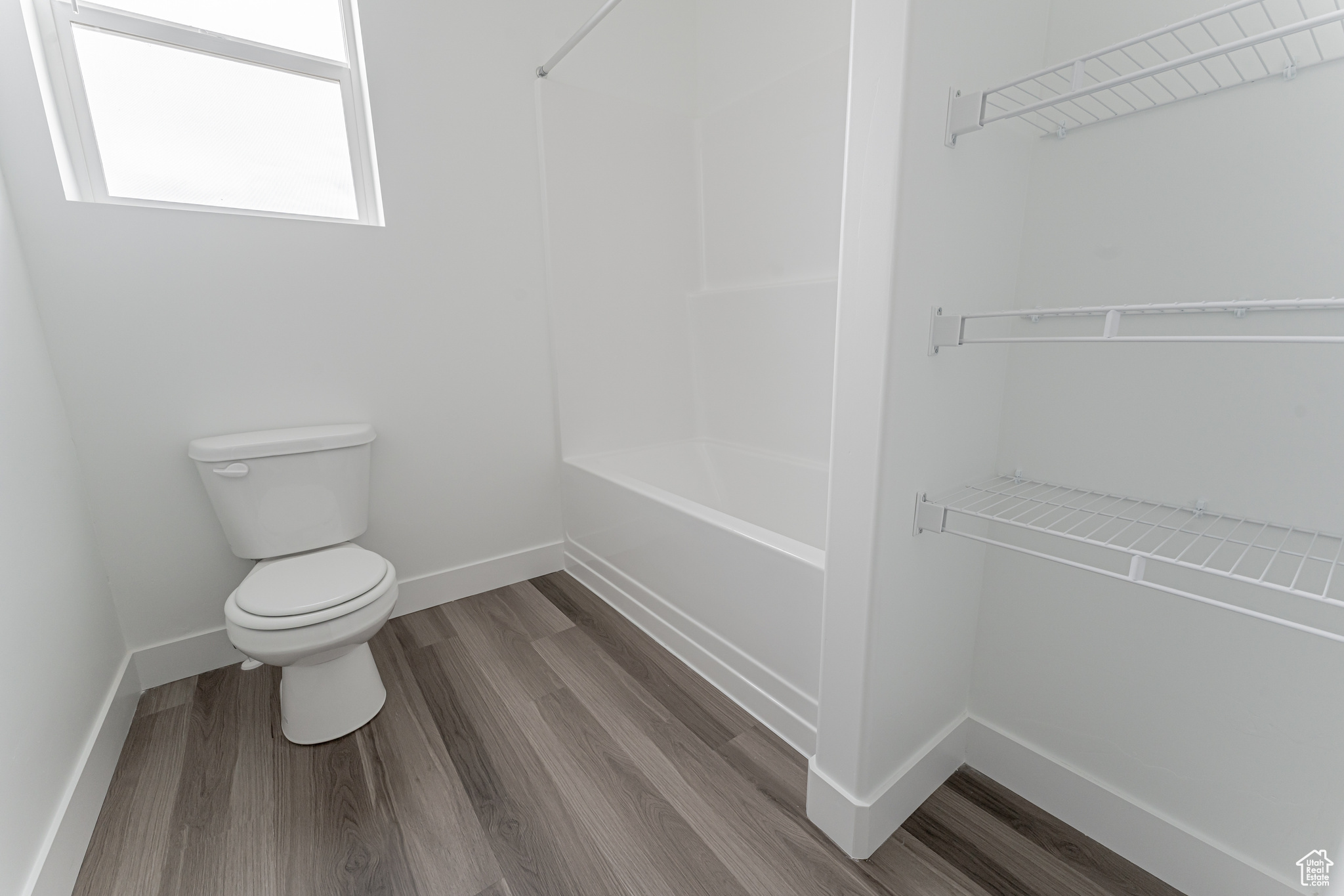 Bathroom with wood-type flooring and toilet