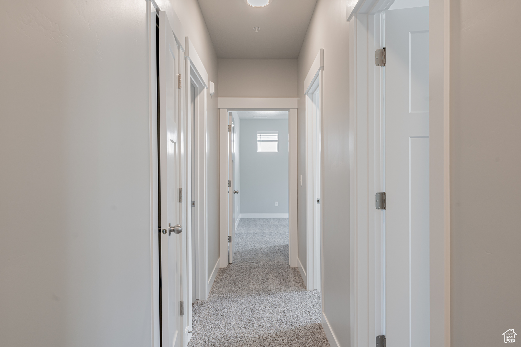 Hallway with light colored carpet