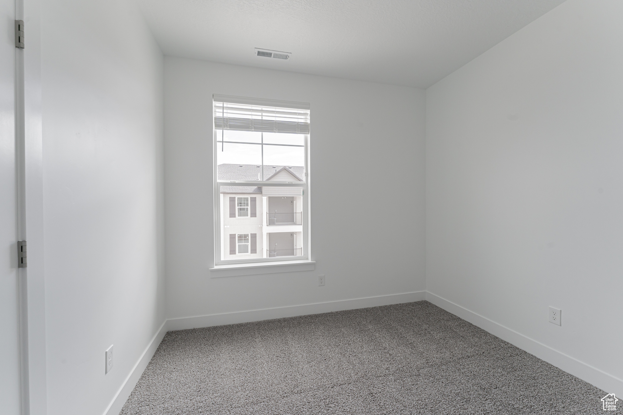 Spare room with carpet and a healthy amount of sunlight