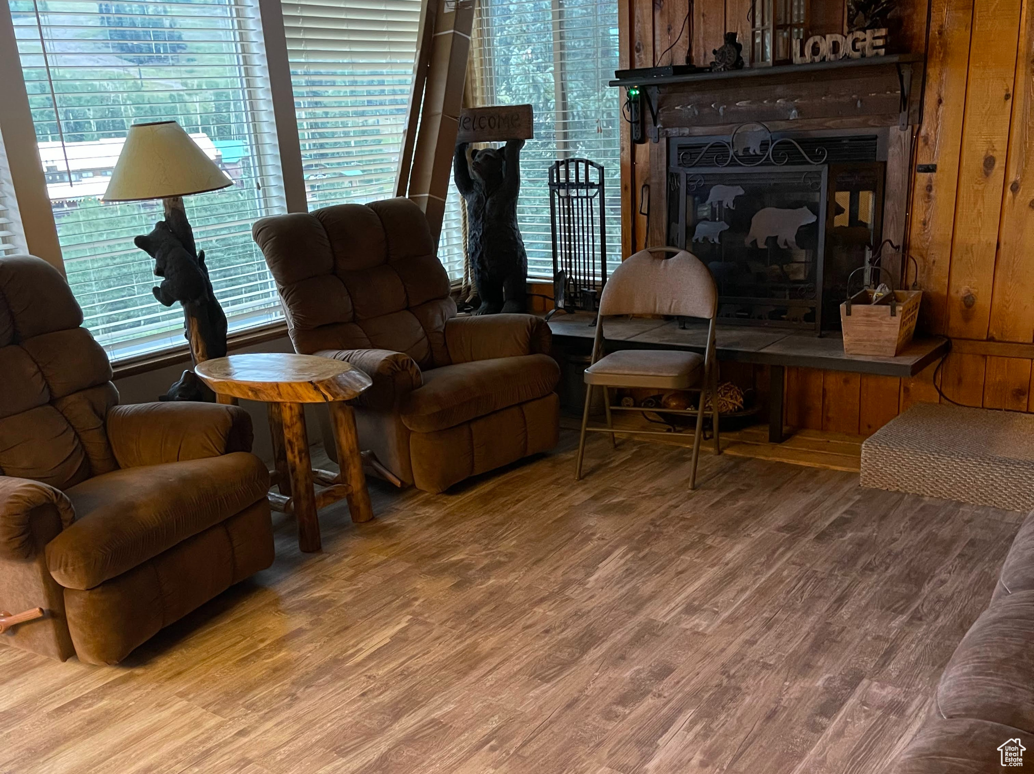 Living room with wood-type flooring and wood walls