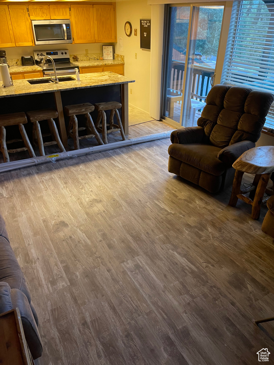 Living room with sink and light wood-type flooring