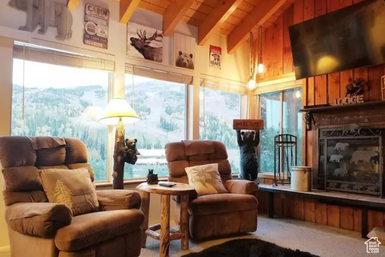 Living room with vaulted ceiling with beams and plenty of natural light