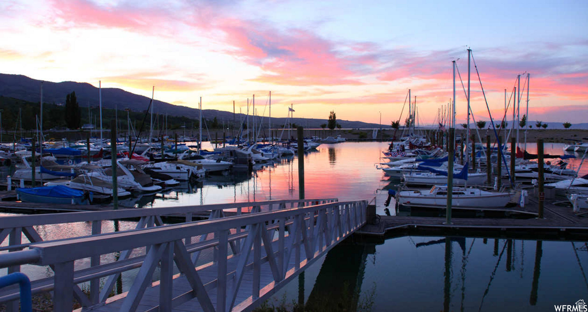 Dock area with a water and mountain view