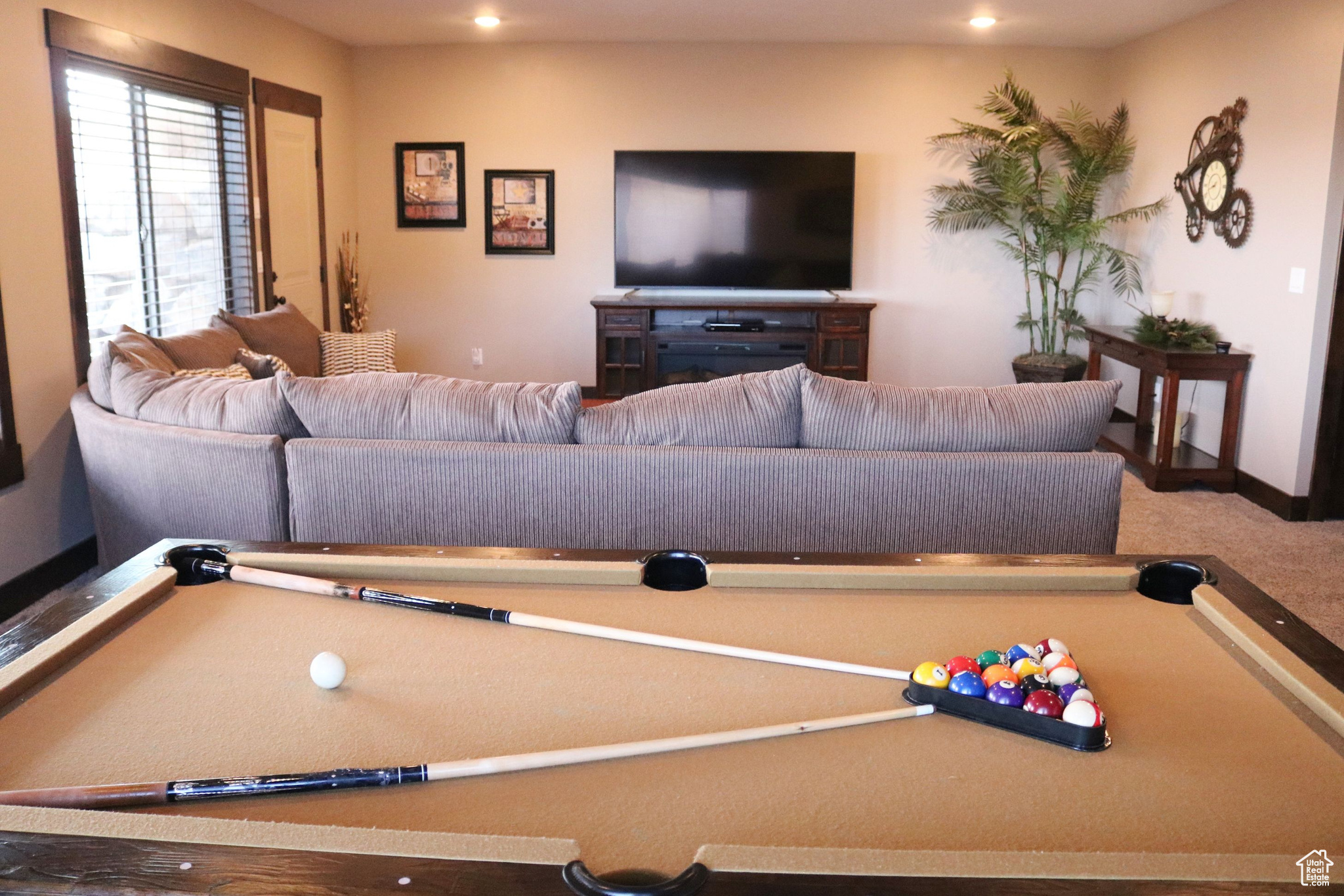 Family room with large sectional, entertainment center and pool table