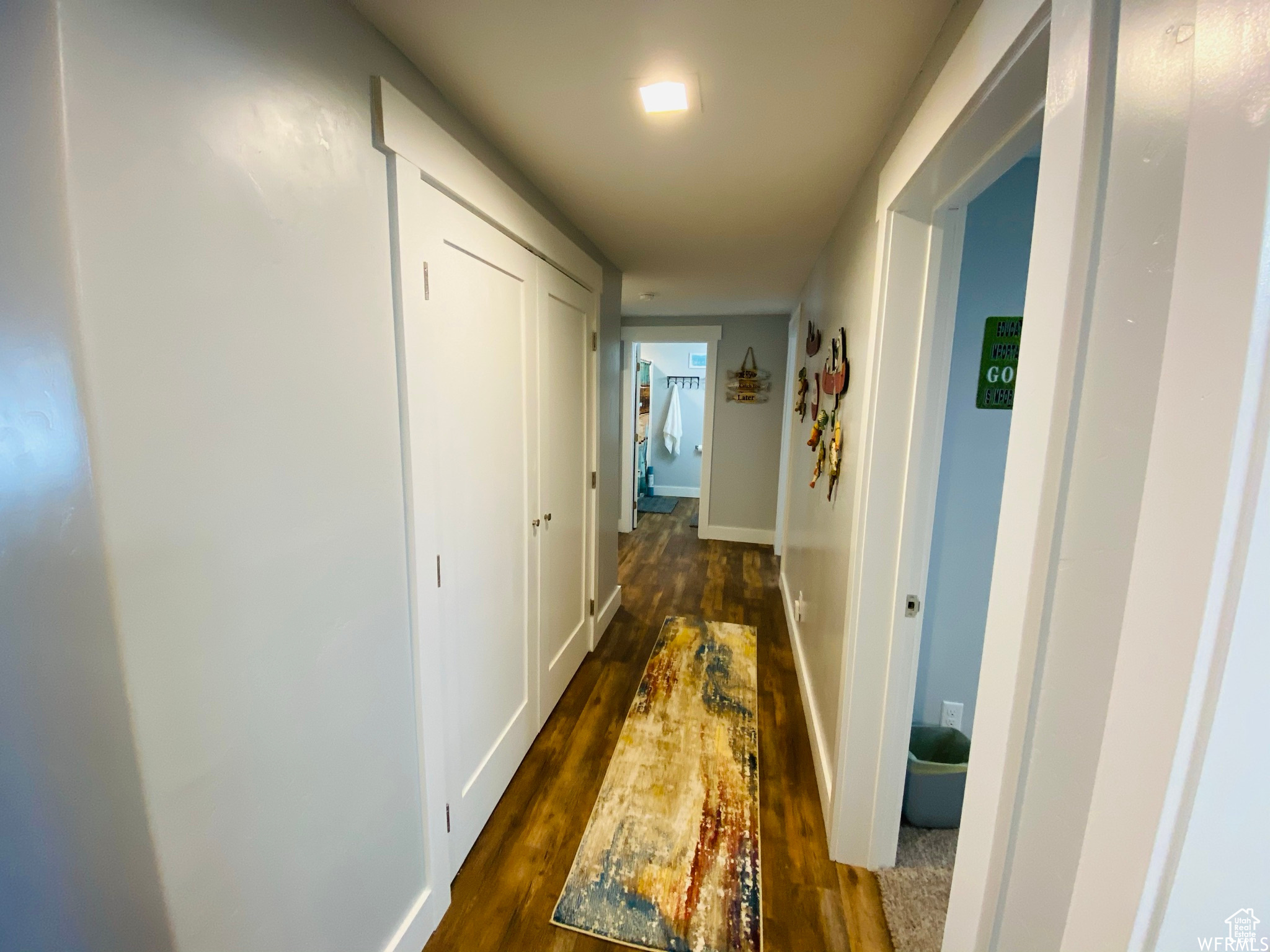 Hallway featuring dark wood-type flooring