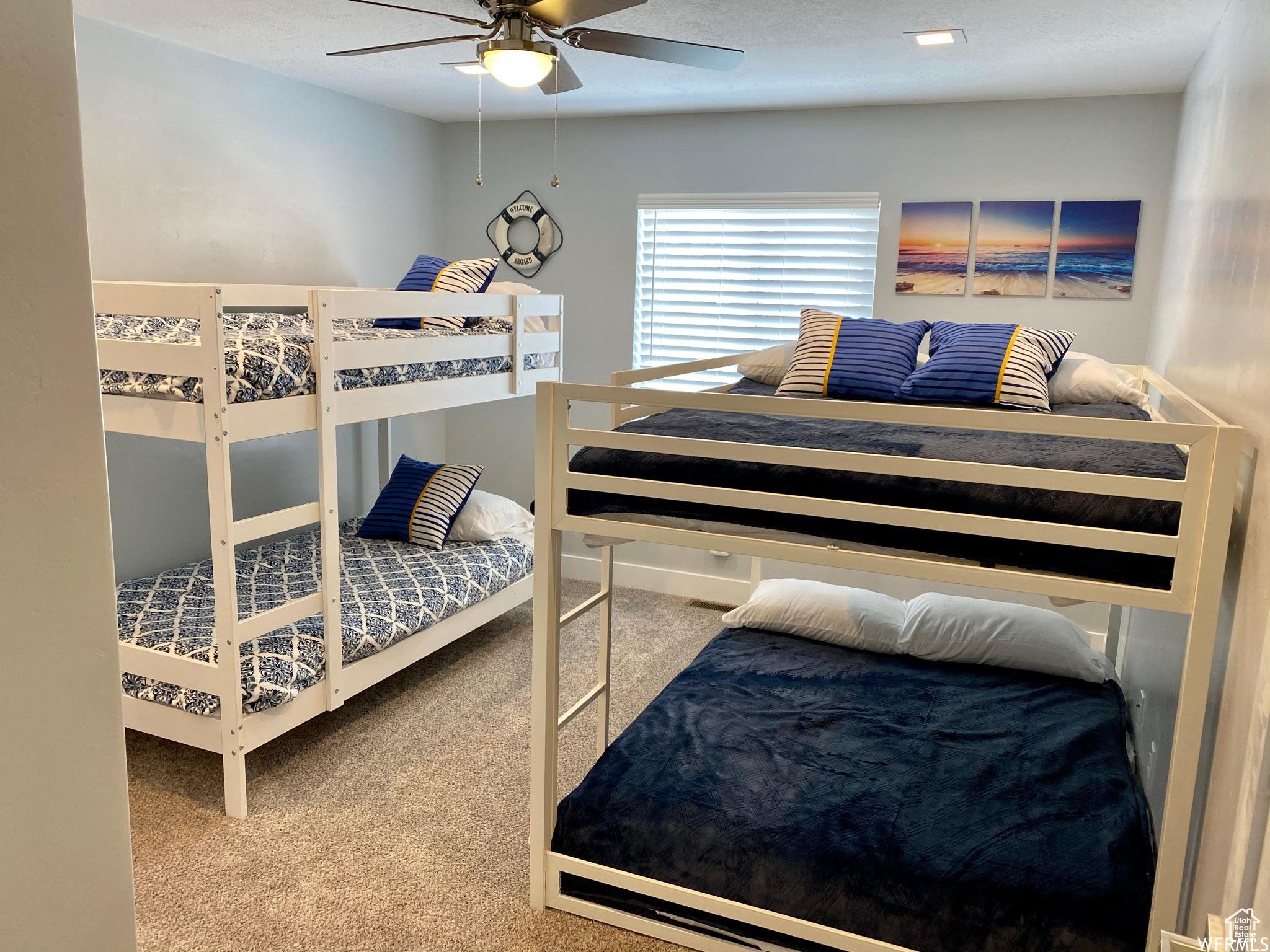 Bedroom featuring light carpet and ceiling fan