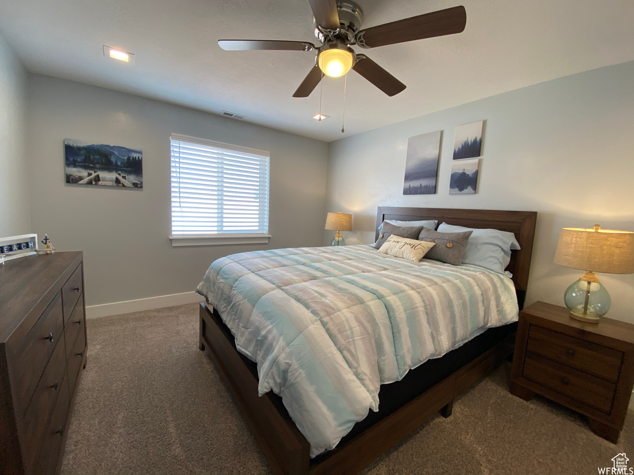 Bedroom with dark colored carpet and ceiling fan