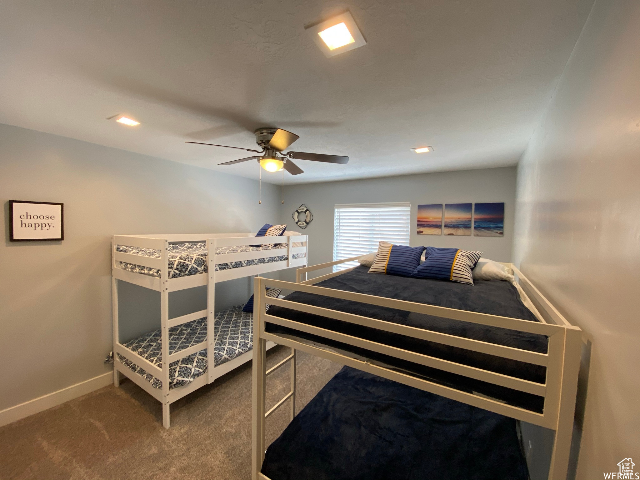 Carpeted bedroom with ceiling fan