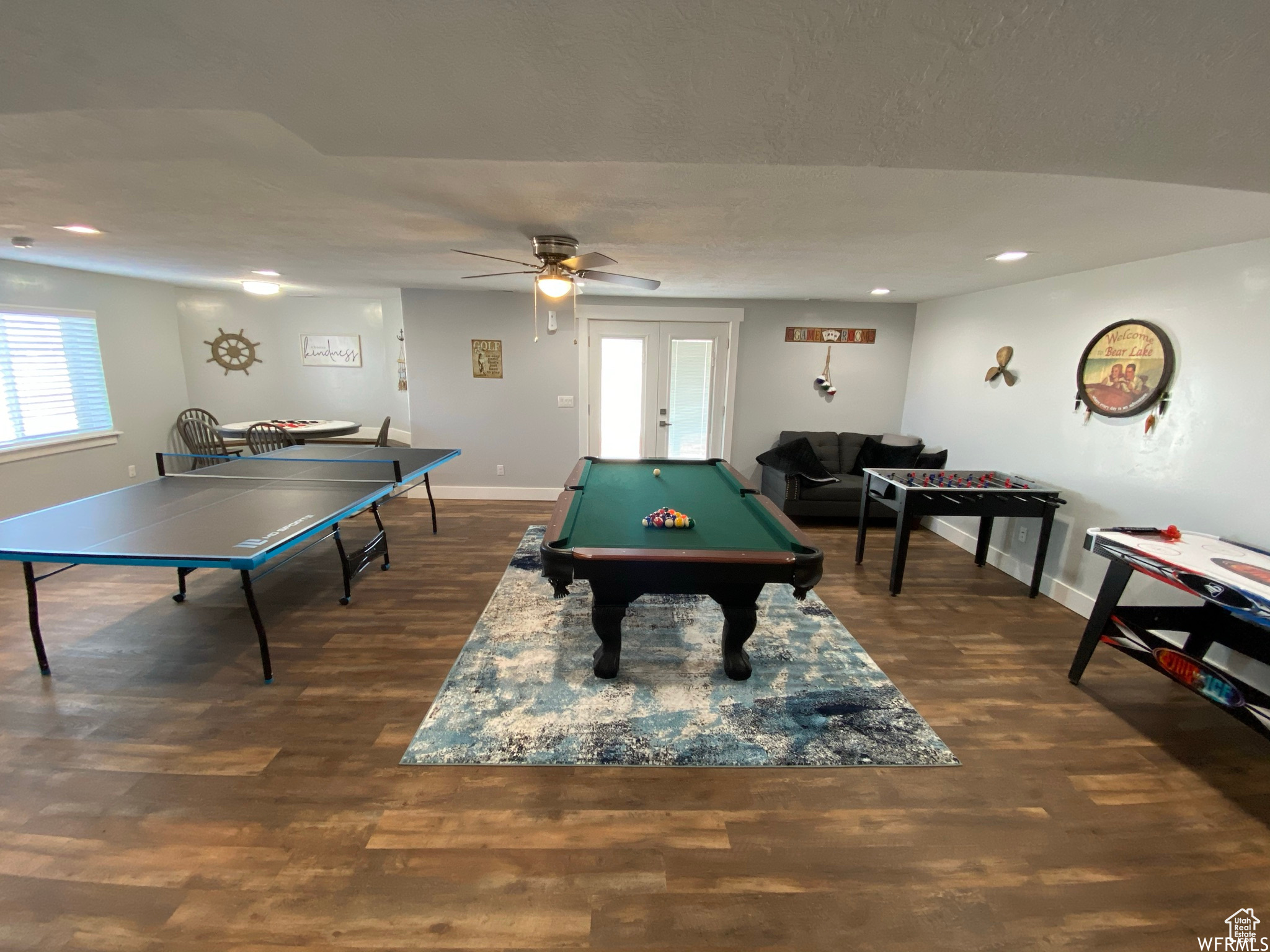 Game room with french doors, dark hardwood / wood-style floors, pool table, and ceiling fan