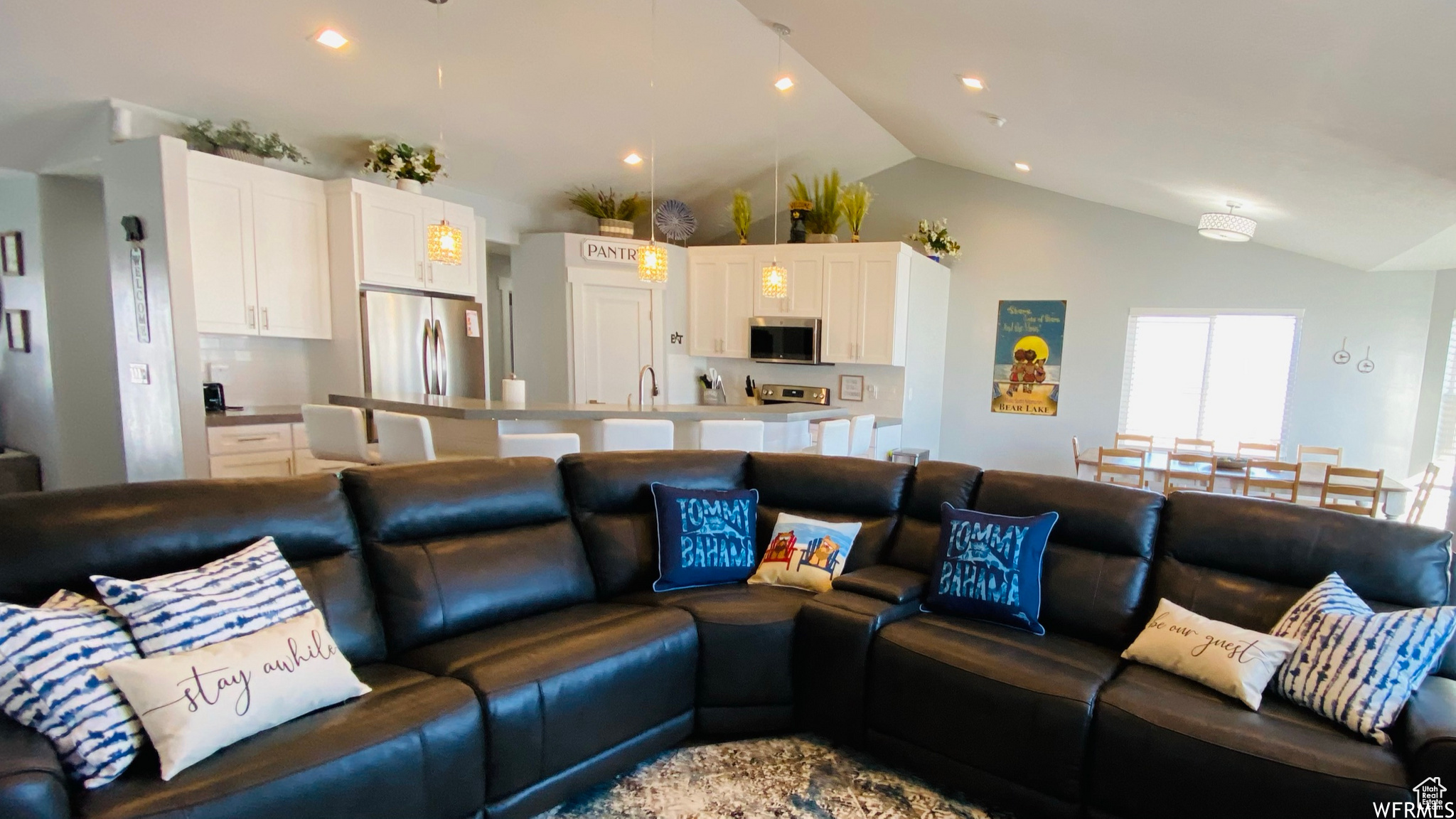 Tiled living room with vaulted ceiling and sink