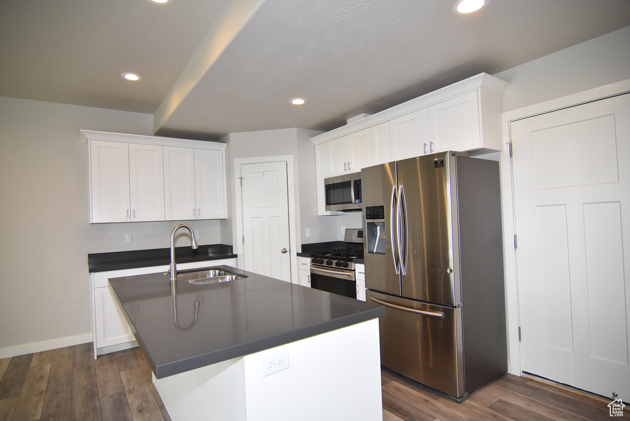 Kitchen with microwave, gas range & fridge