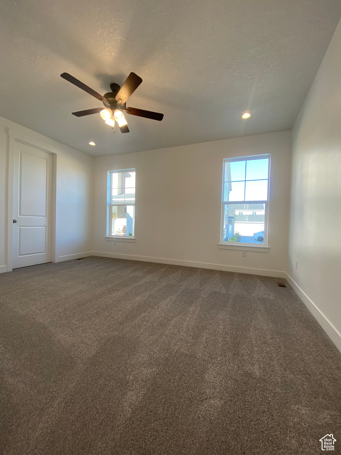 Carpeted spare room with ceiling fan and a textured ceiling. Pictures are for reference only of the MAINE floor plan. Actual finishes may vary.