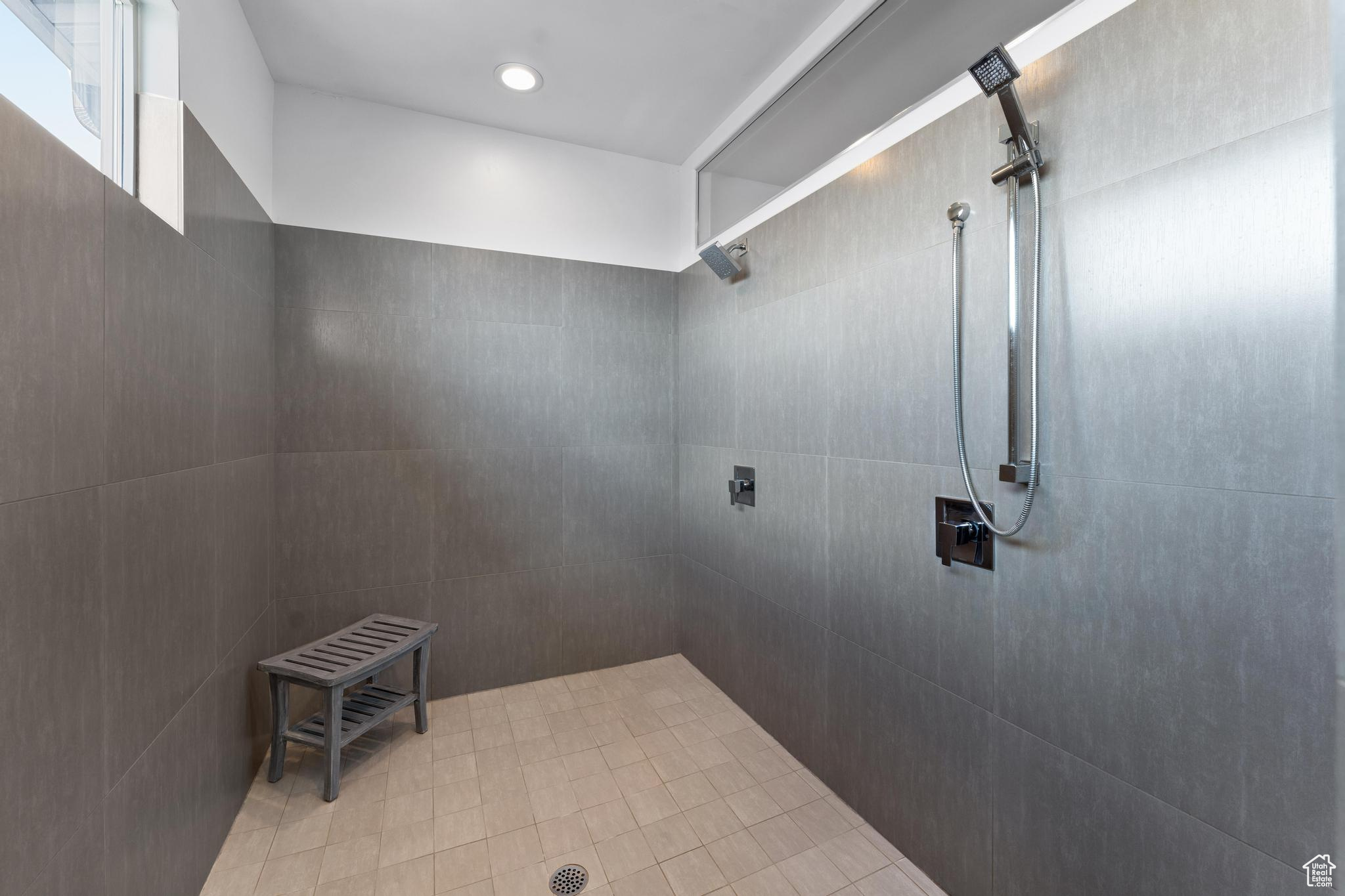 Bathroom featuring tiled shower and tile flooring