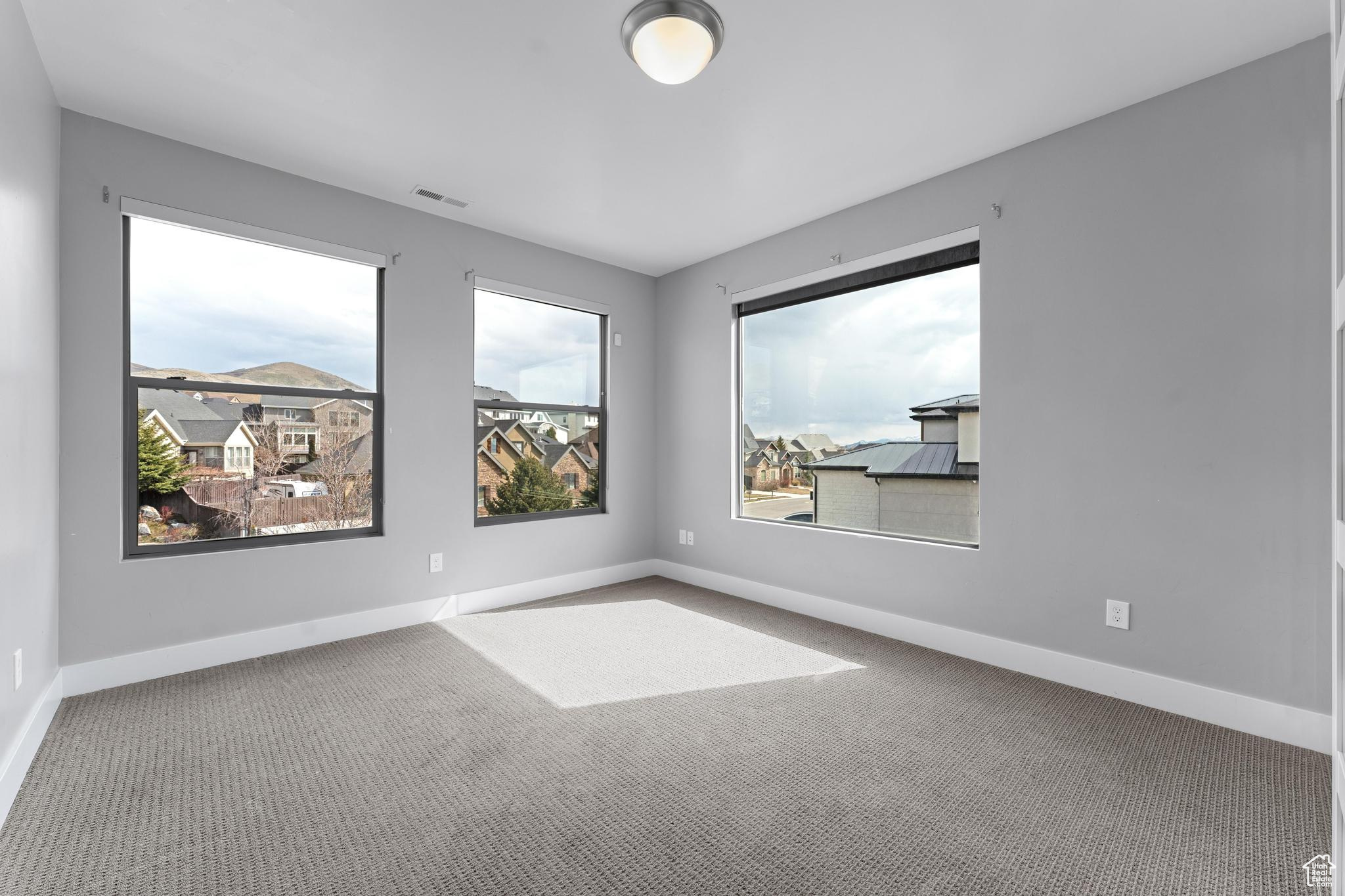 View of carpeted spare room