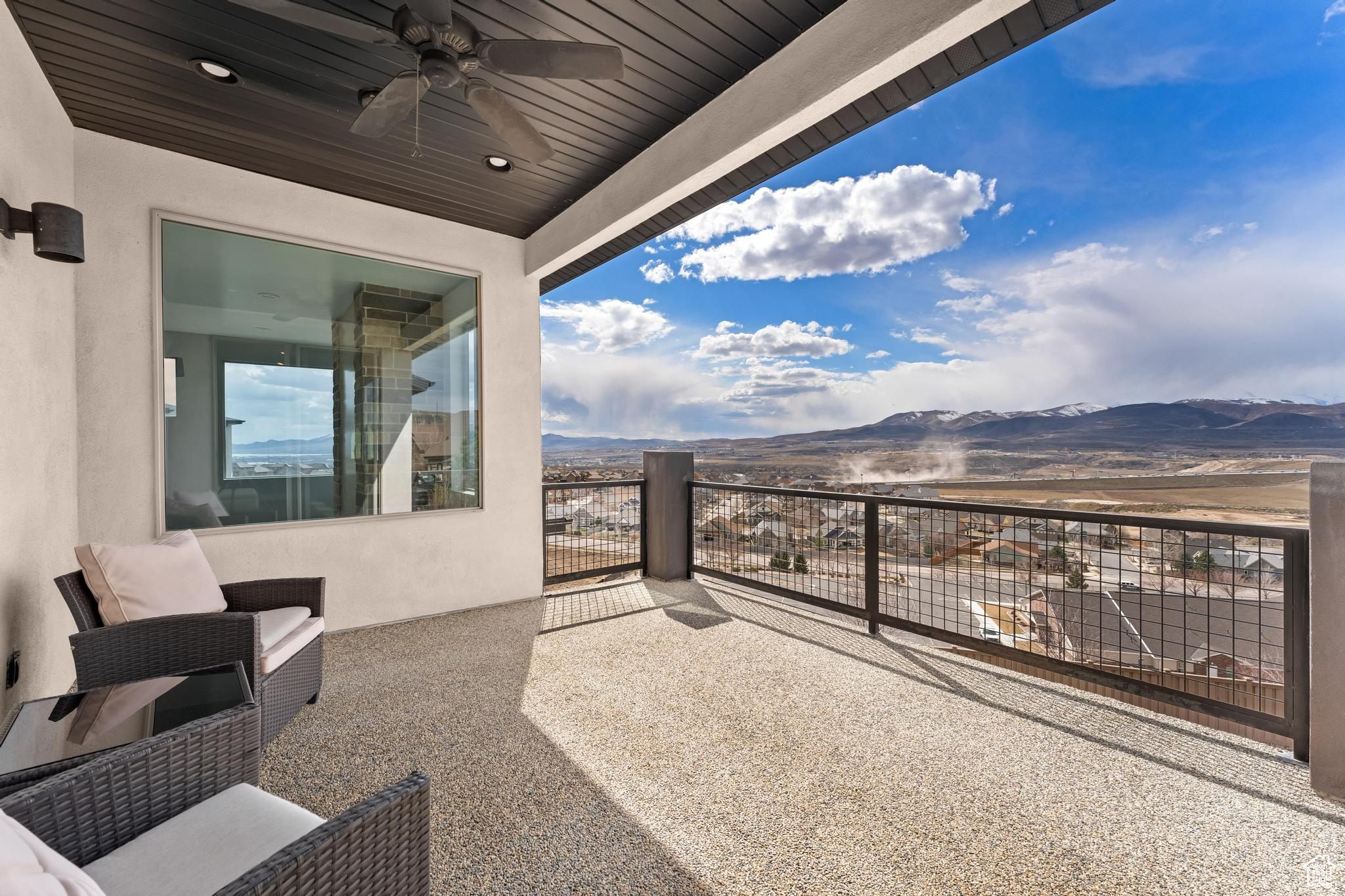 Balcony with a mountain view and ceiling fan