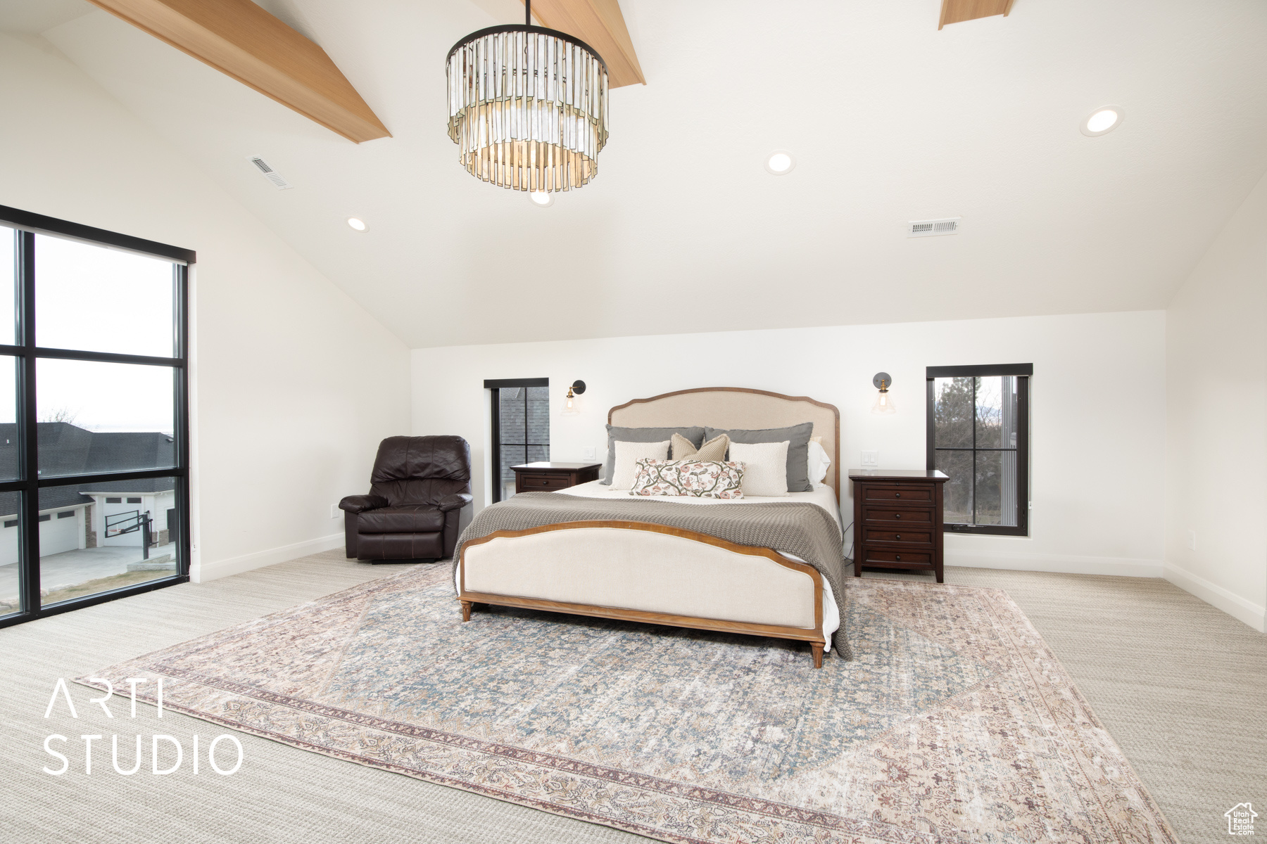 Primary bedroom featuring light colored carpet, a chandelier, high vaulted ceiling, and beam ceiling