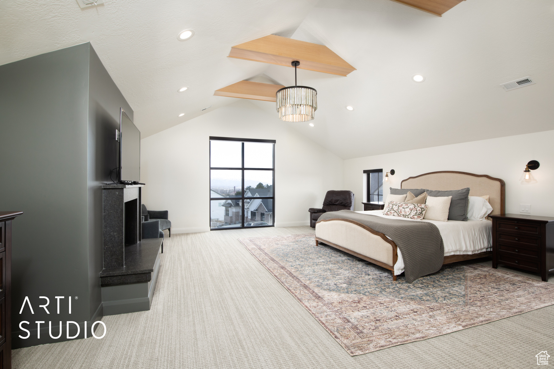 Primary bedroom featuring lofted ceiling with beams, light carpet, and a chandelier