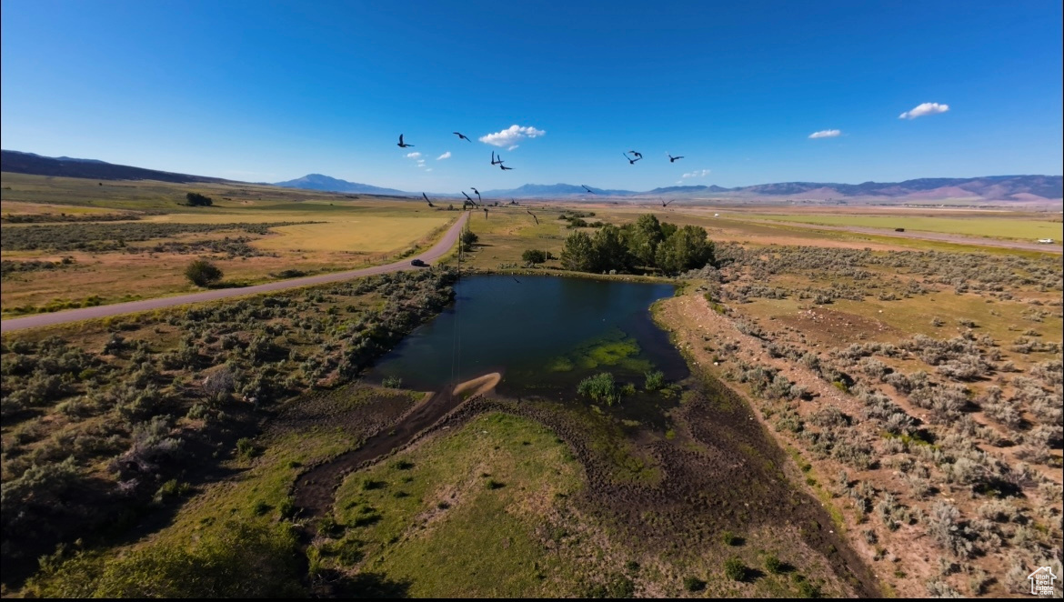 Aerial view with a rural view and a water and mountain view