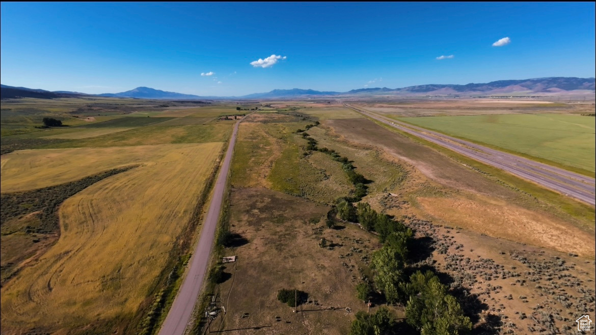 Birds eye view of property with a mountain view and a rural view